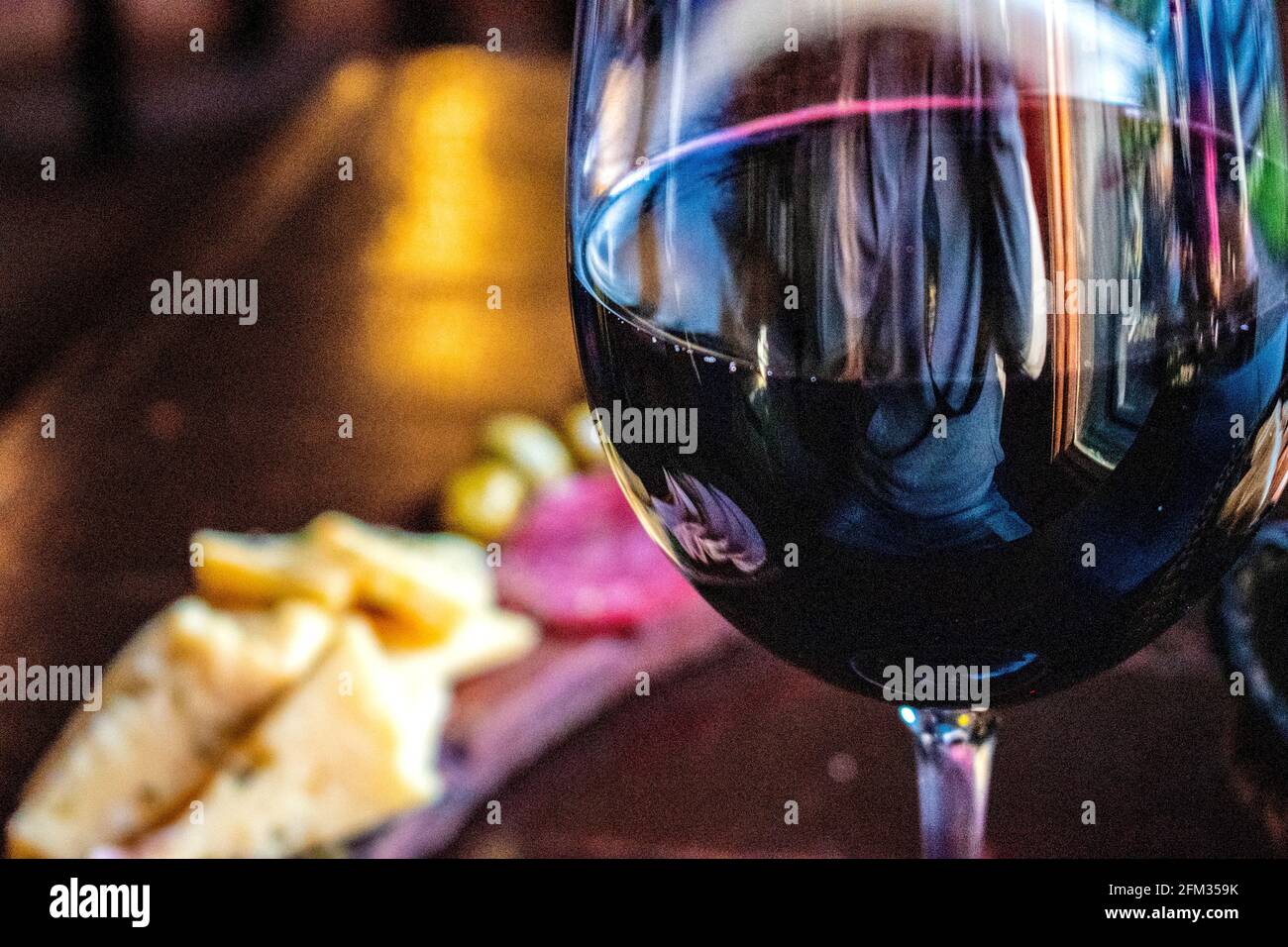 Glass of red wine with cold cuts and cheeses ("picada Stock Photo Alamy