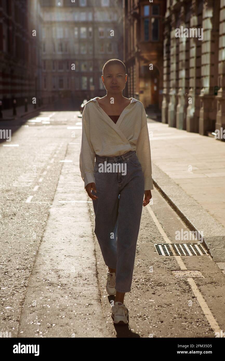 London, UK. 18th Apr, 2021. A model wearing a white shirt and Jeans, Reebok  trainers during a street style photoshoot in central London. Credit: SOPA  Images Limited/Alamy Live News Stock Photo -