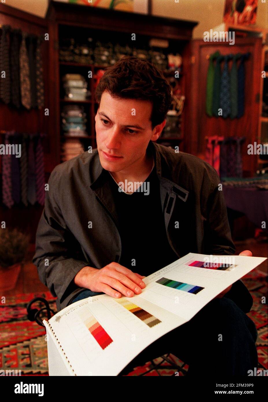 Ioan Gruffudd Welsh actor June 1999looks at colour charts before being measured for his Kelsey suit Stock Photo