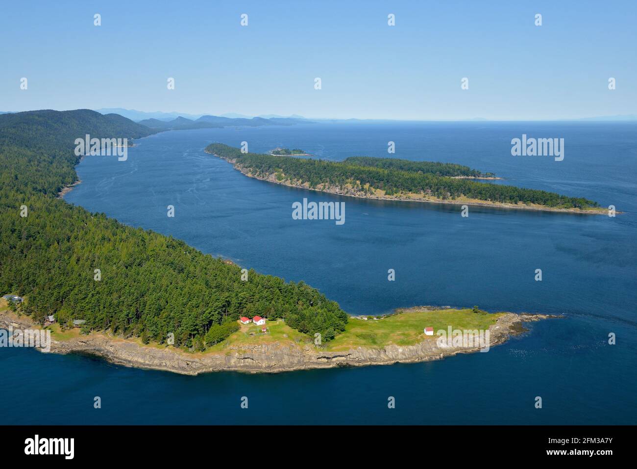East Point Light station with Tumbo Island in the background, Gulf Islands National Park Reserve of Canada, Saturna Island, British Columbia, Canada. Stock Photo