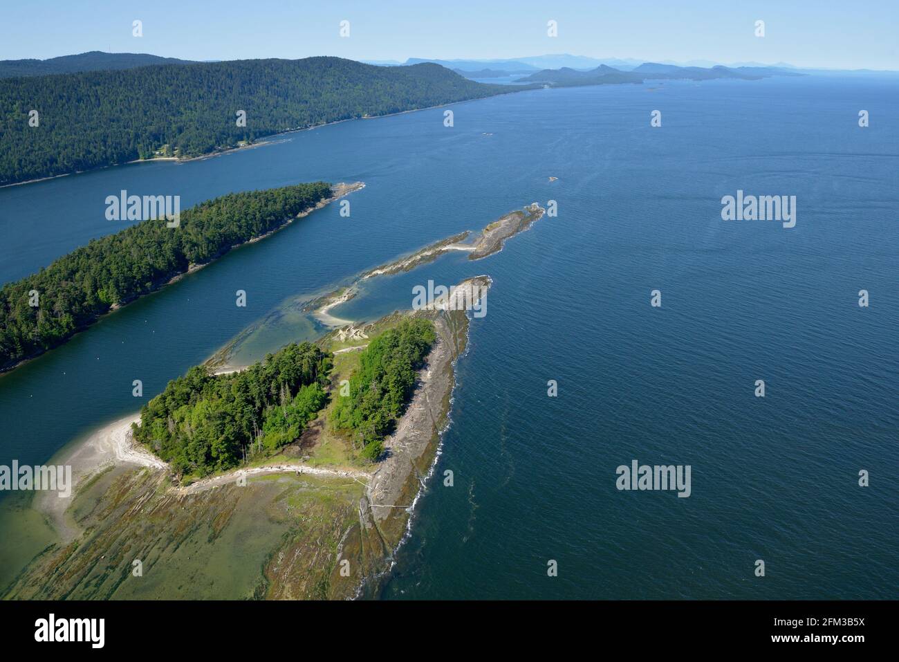 Aerial photo of Cabbage Island and reefs with Saturna Island in the background, Gulf Islands