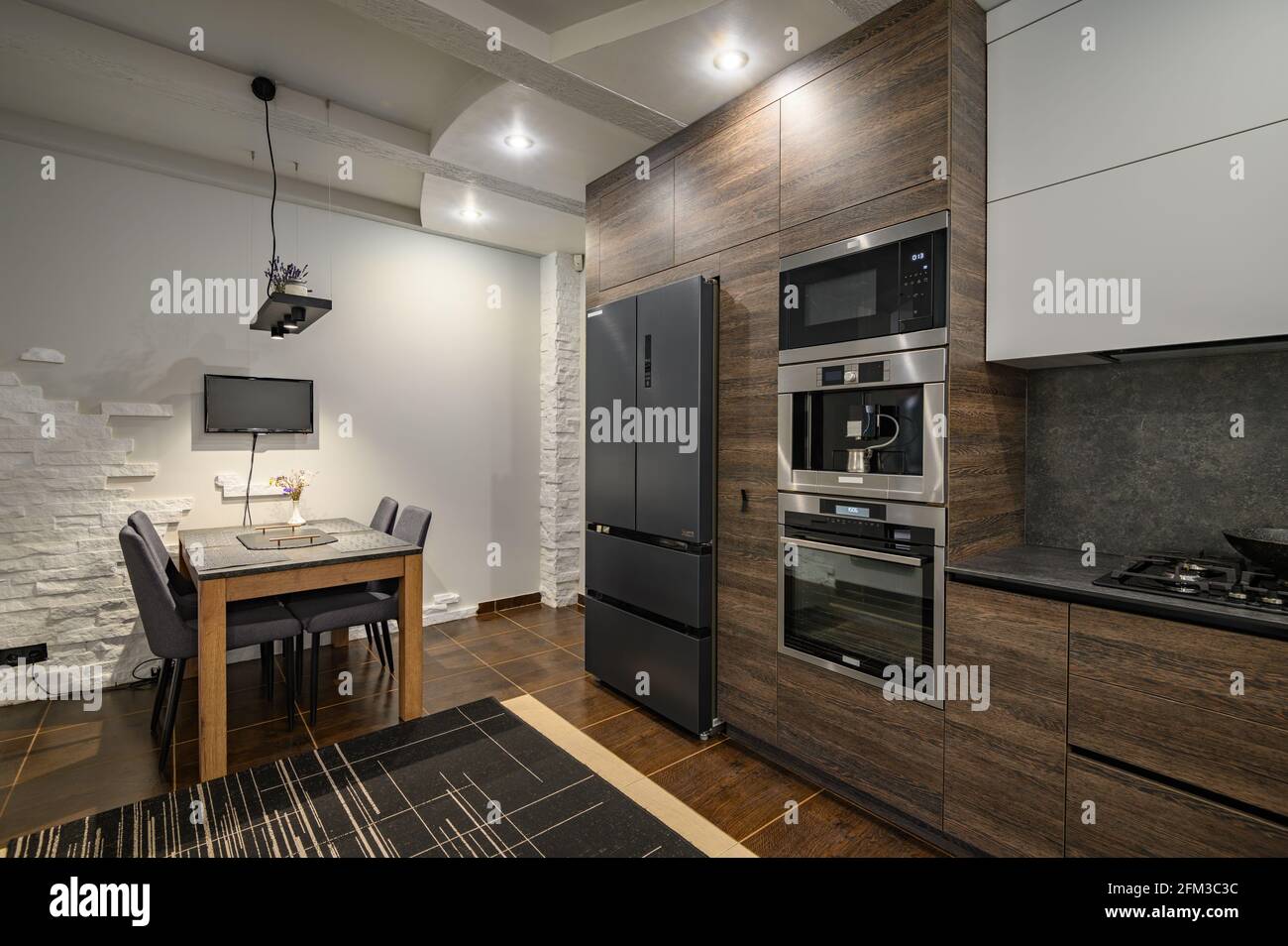 Modern luxurious dark brown, gray and black kitchen details Stock Photo