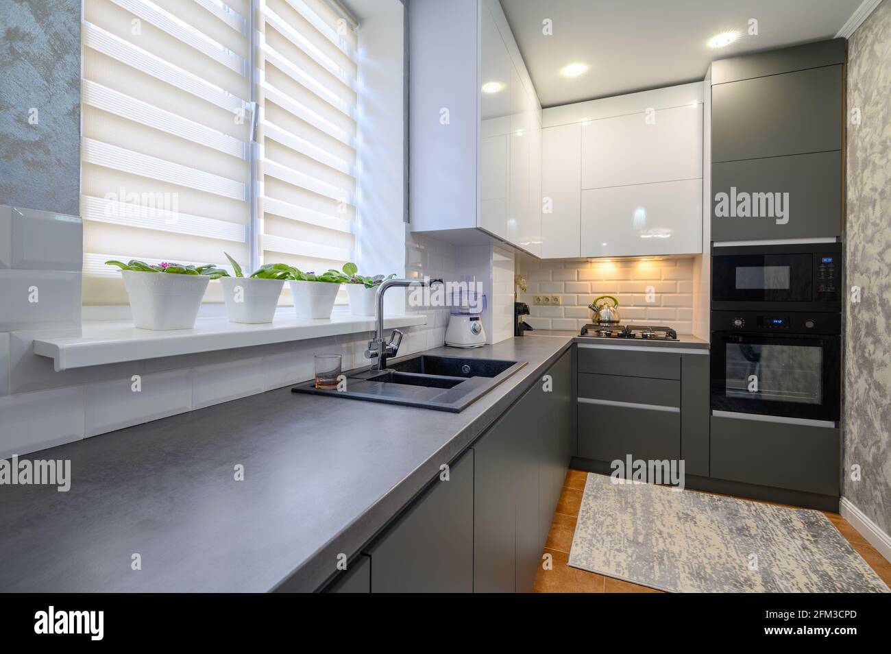 Modern dark grey small kitchen interior Stock Photo - Alamy