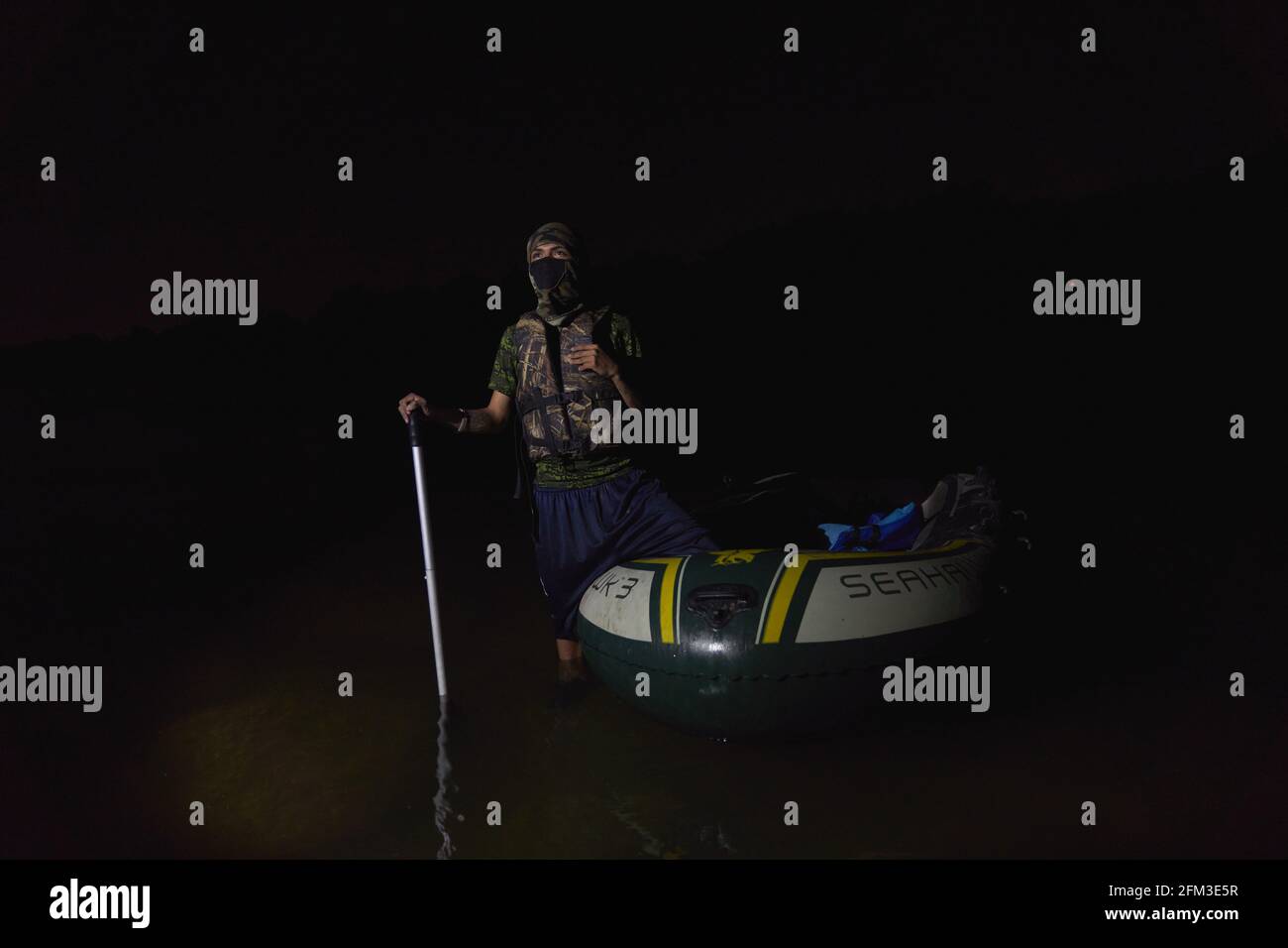 Roma, Texas, USA. 3rd May, 2021. A 17 year old smuggler sits on his