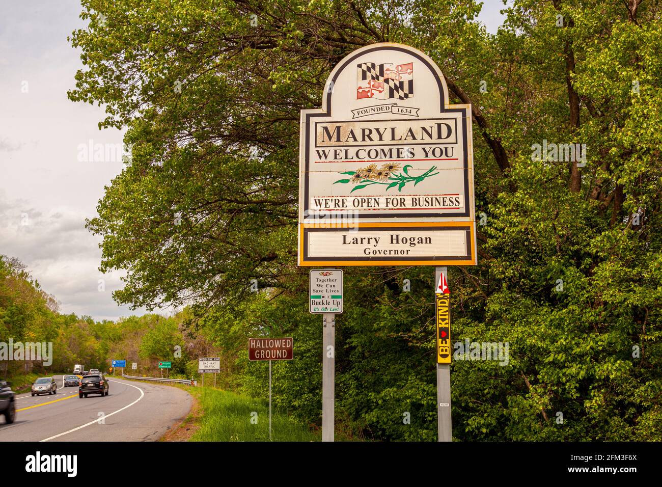 Maryland Welcomes You road sign on the scenic byway US Route 15 at the border of Maryland and Virginia.  It has MD flag and says open for business. Stock Photo