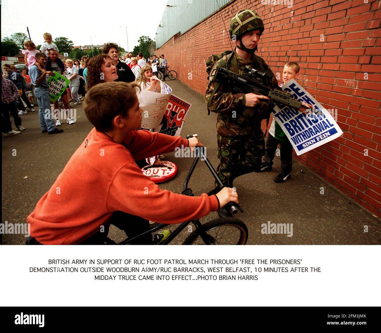 Northern Ireland IRA Ceasefire July 1997 Young catholic children taunt Young British soldier at the Free the Prisoners demonstration outside Woodburn Army/RUC Barracks in West Belfast ten minutes after the renewed IRA