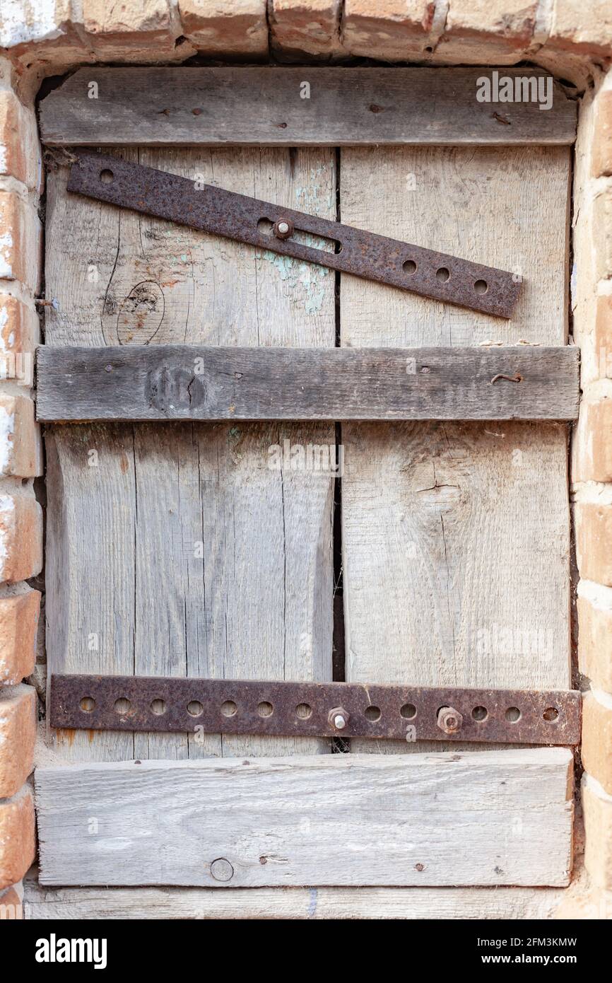 boarded-up window close up, place under the text Stock Photo