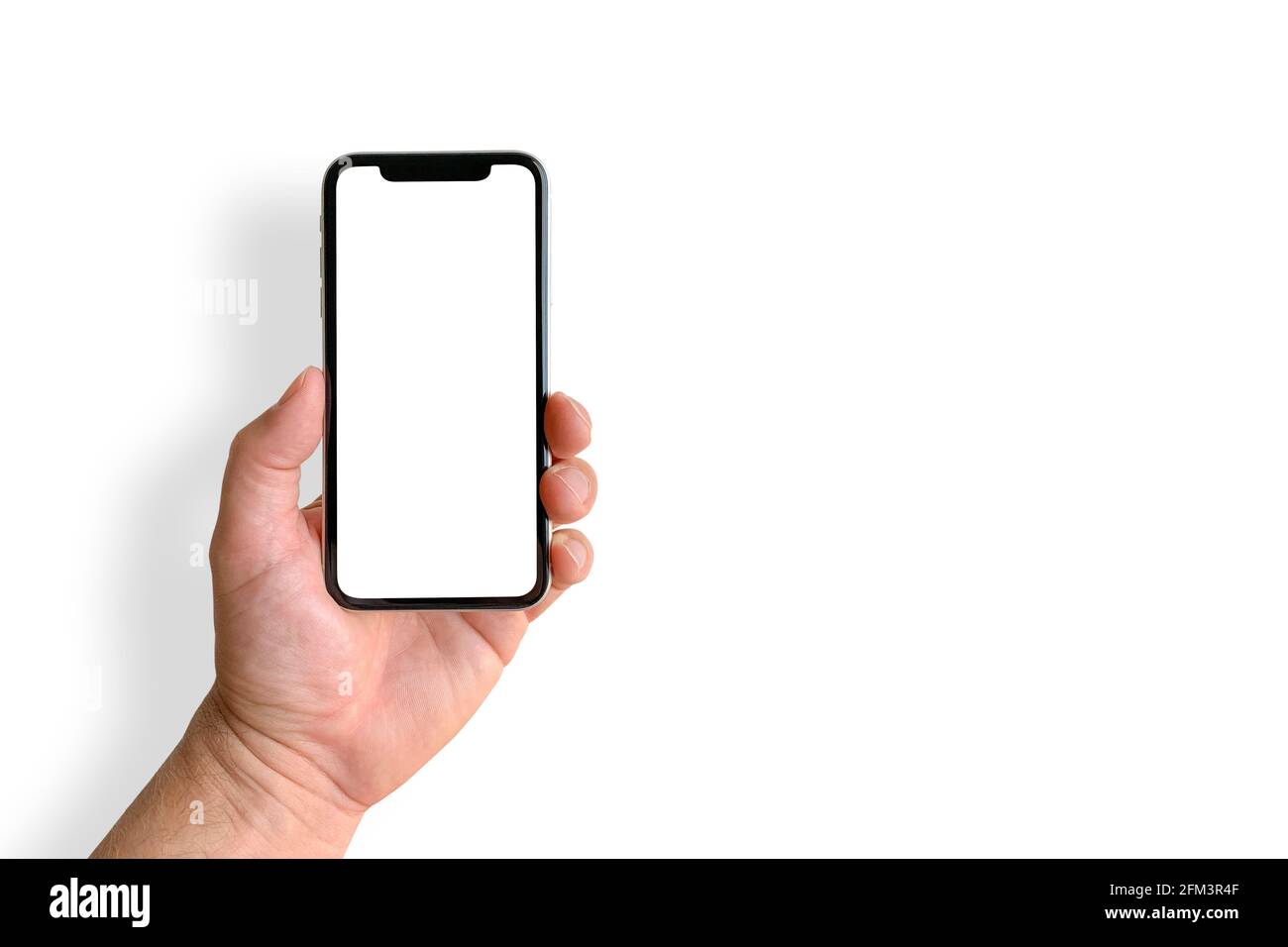 Man holding mobile phone with blank screen on white background, closeup of hand. Space for text Stock Photo