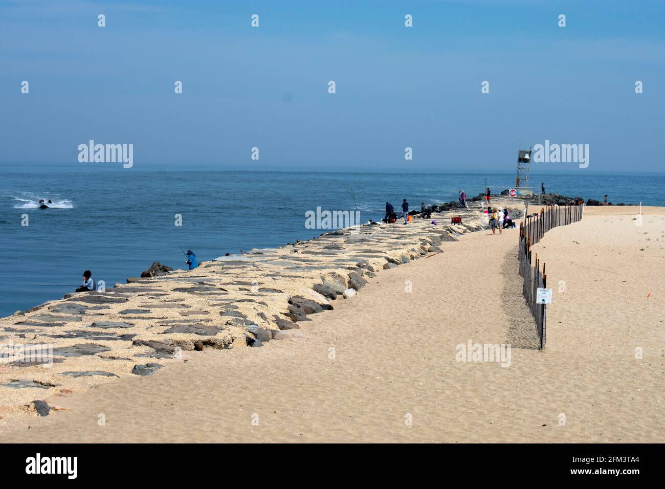 Boats and fishermen line the jetties and inlet at Belmar, New Jersey