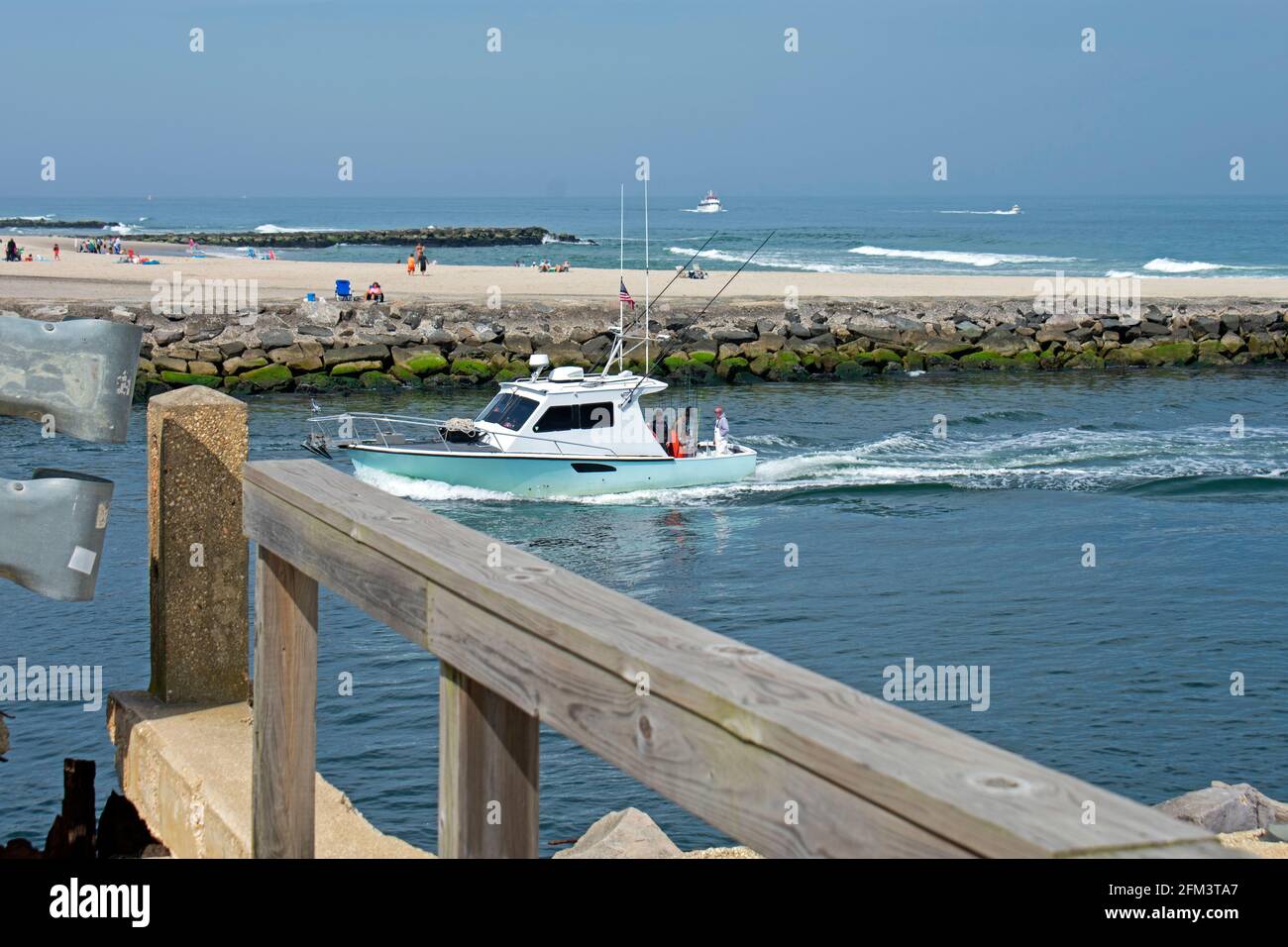 Boats and fishermen line the jetties and inlet at Belmar, New Jersey