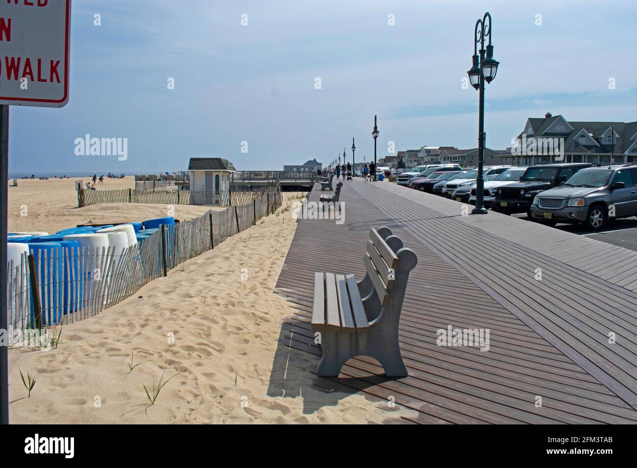 Relatively empty beach boardwalk on a warm spring day in Belmar, New Jersey -01 Stock Photo