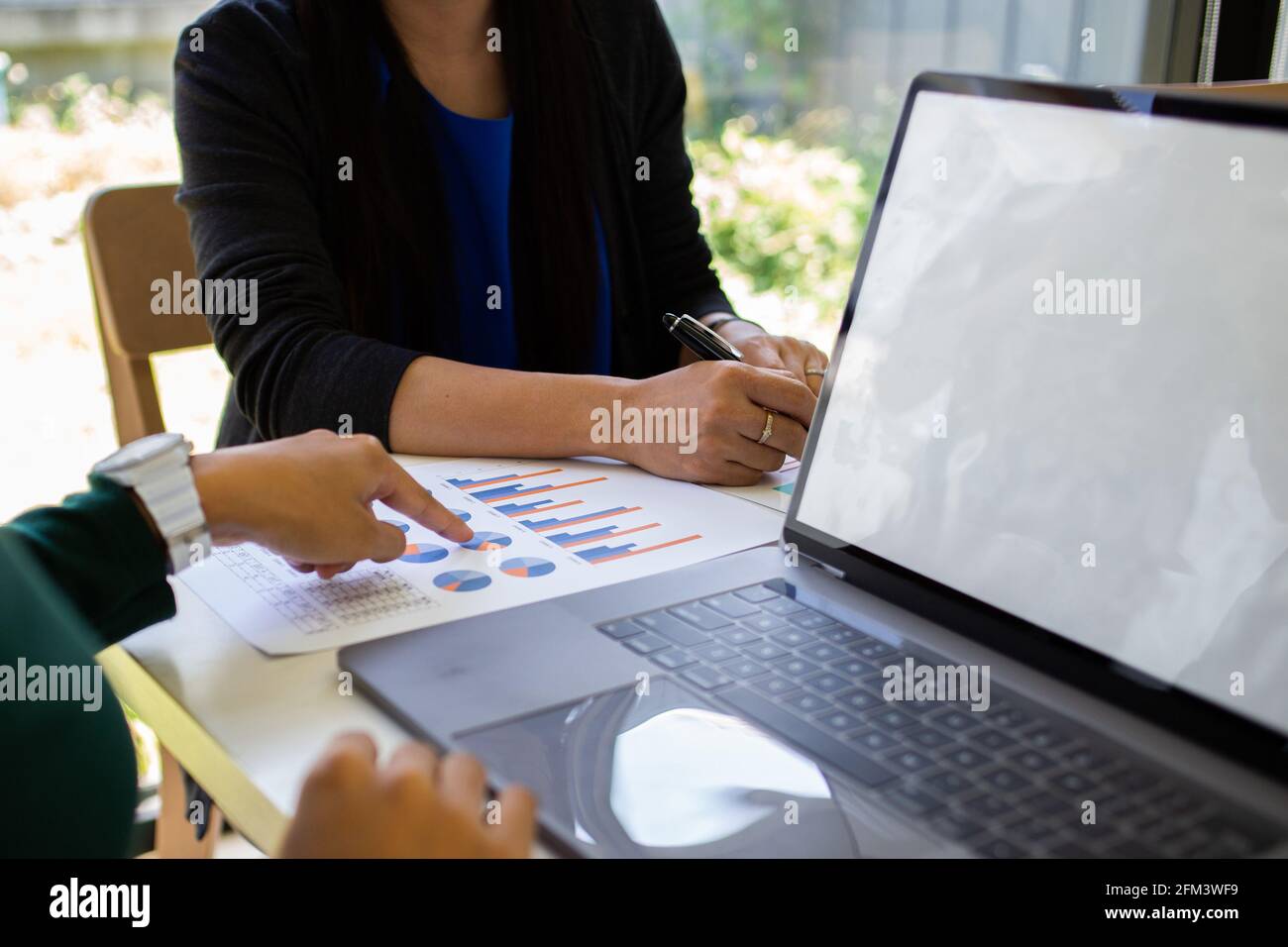 Business analysts make decisions about the US economy that affect future operations of the company. Stock Photo