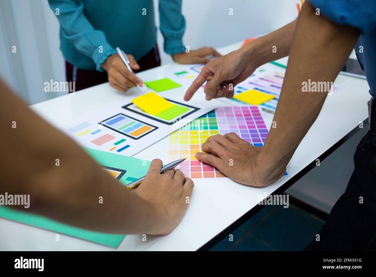 team designers Presentation model mobile phone screen to suit their usage.UX UI and Programming Stock Photo