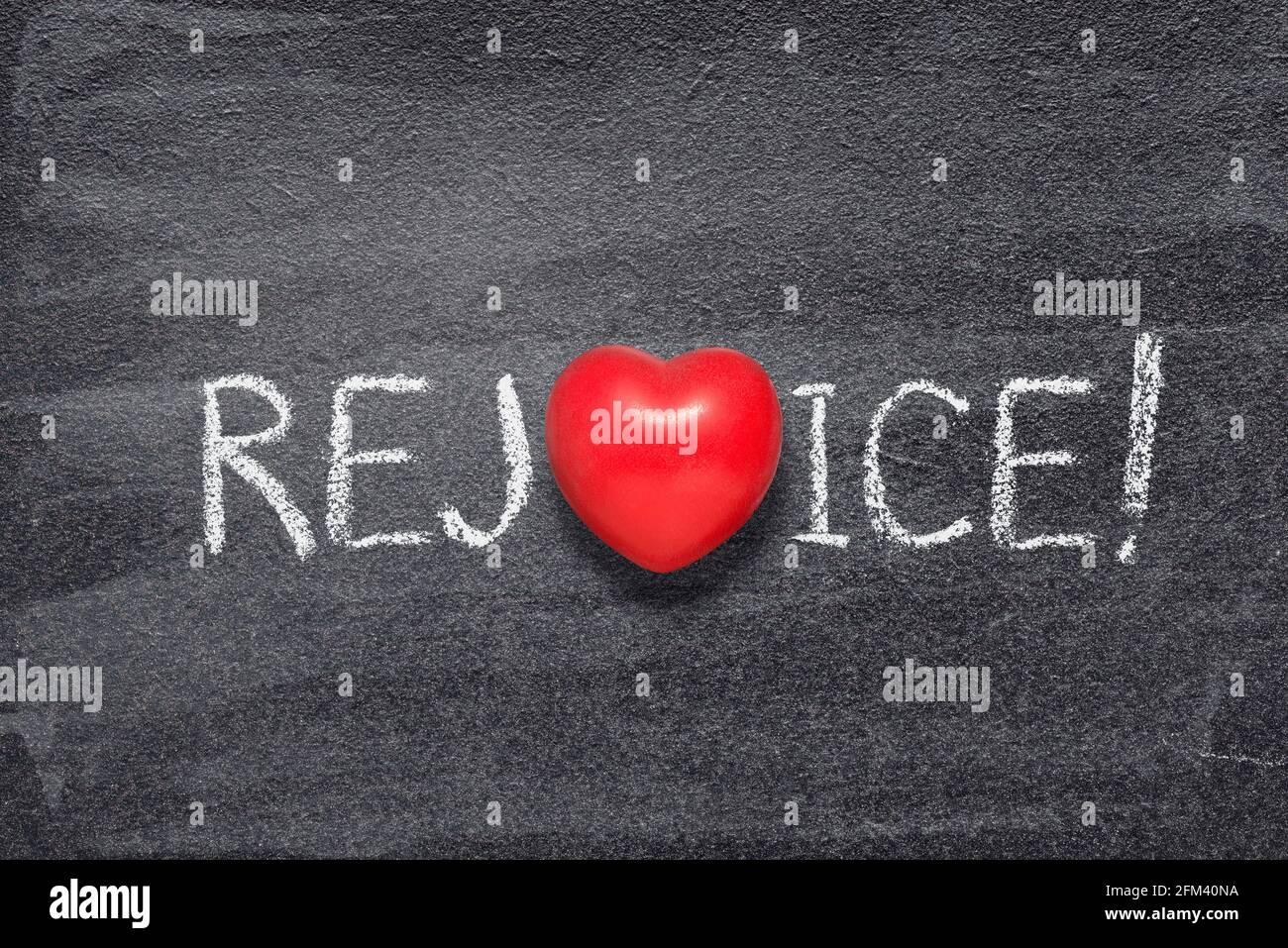 rejoice word written on chalkboard with red heart symbol Stock Photo