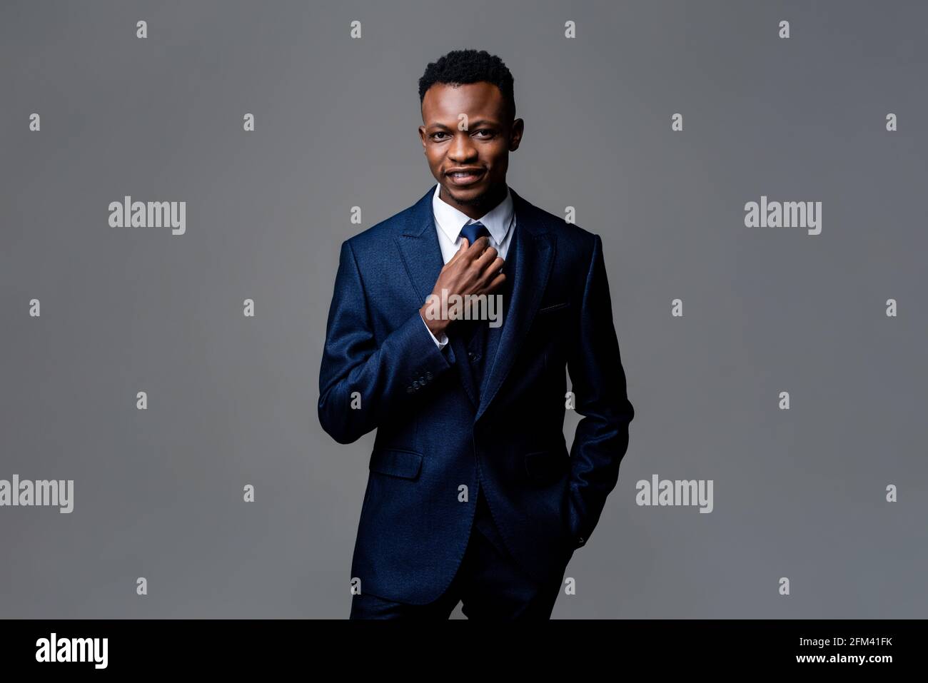 Portrait of young smiling happy handsome African man wearing formal ...