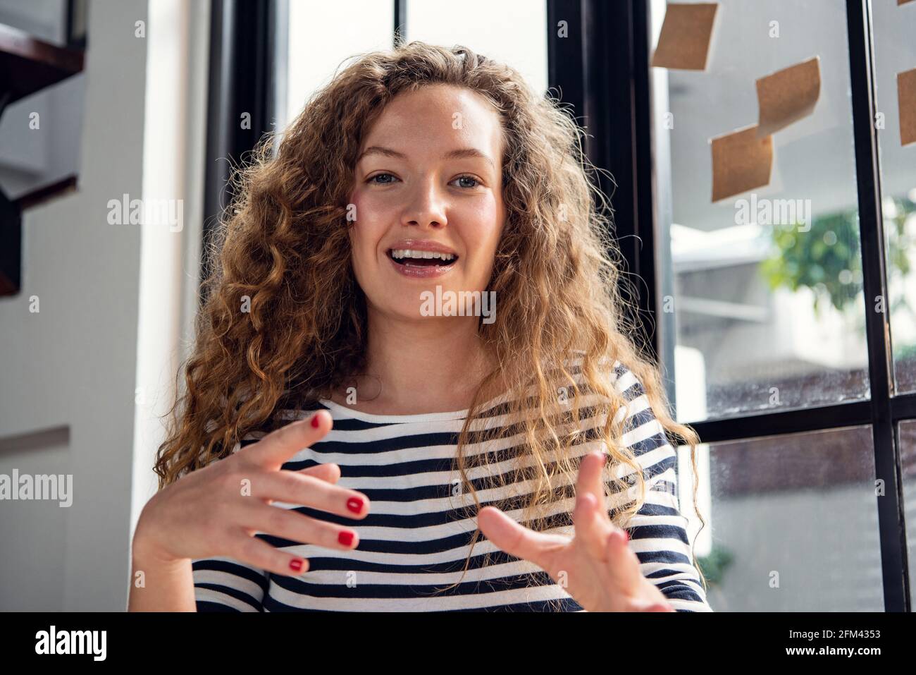 Happy cheerful pretty Caucasian woman smiling and  talking while making video call conference for social distancing and work from home comcept Stock Photo