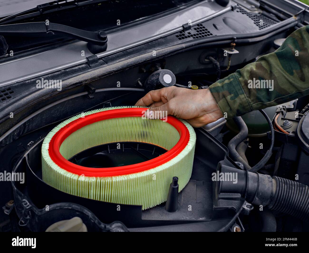Man replaced air filter on engine of car Stock Photo Alamy
