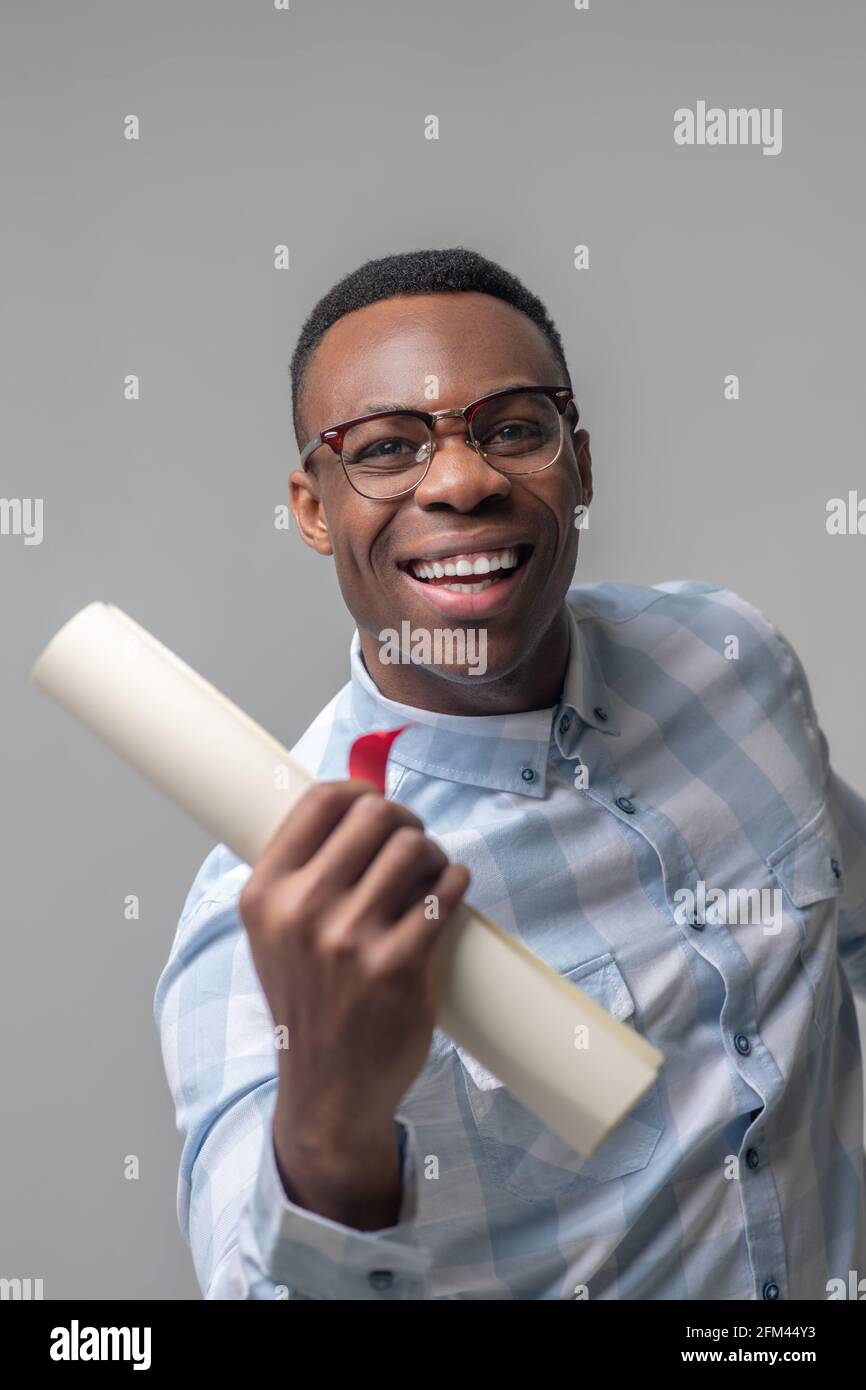 Energetic happy dark skinned man with glasses Stock Photo