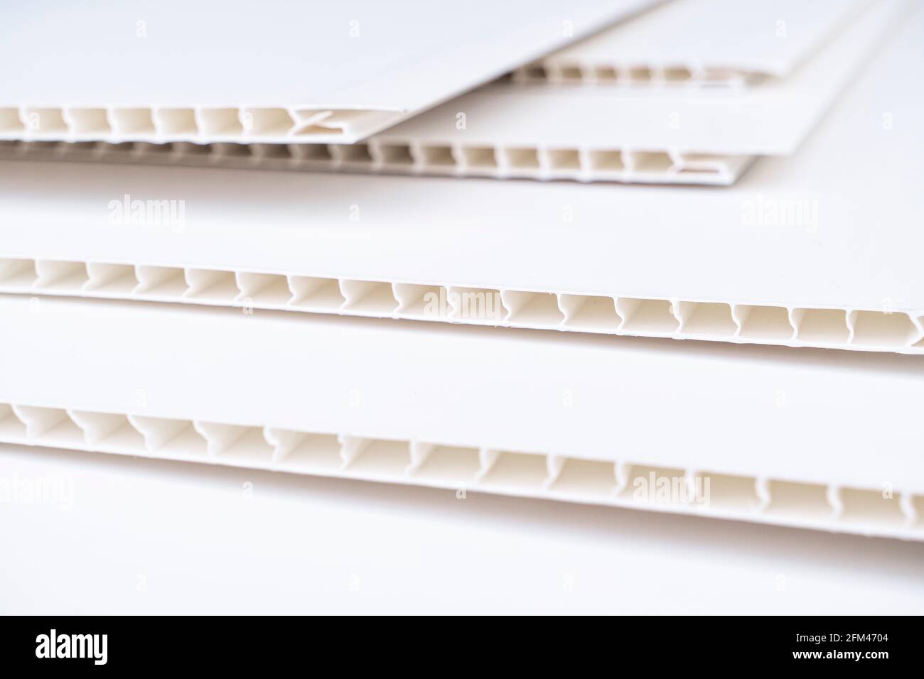 Construction vinyl siding panels pattern. House covered with white