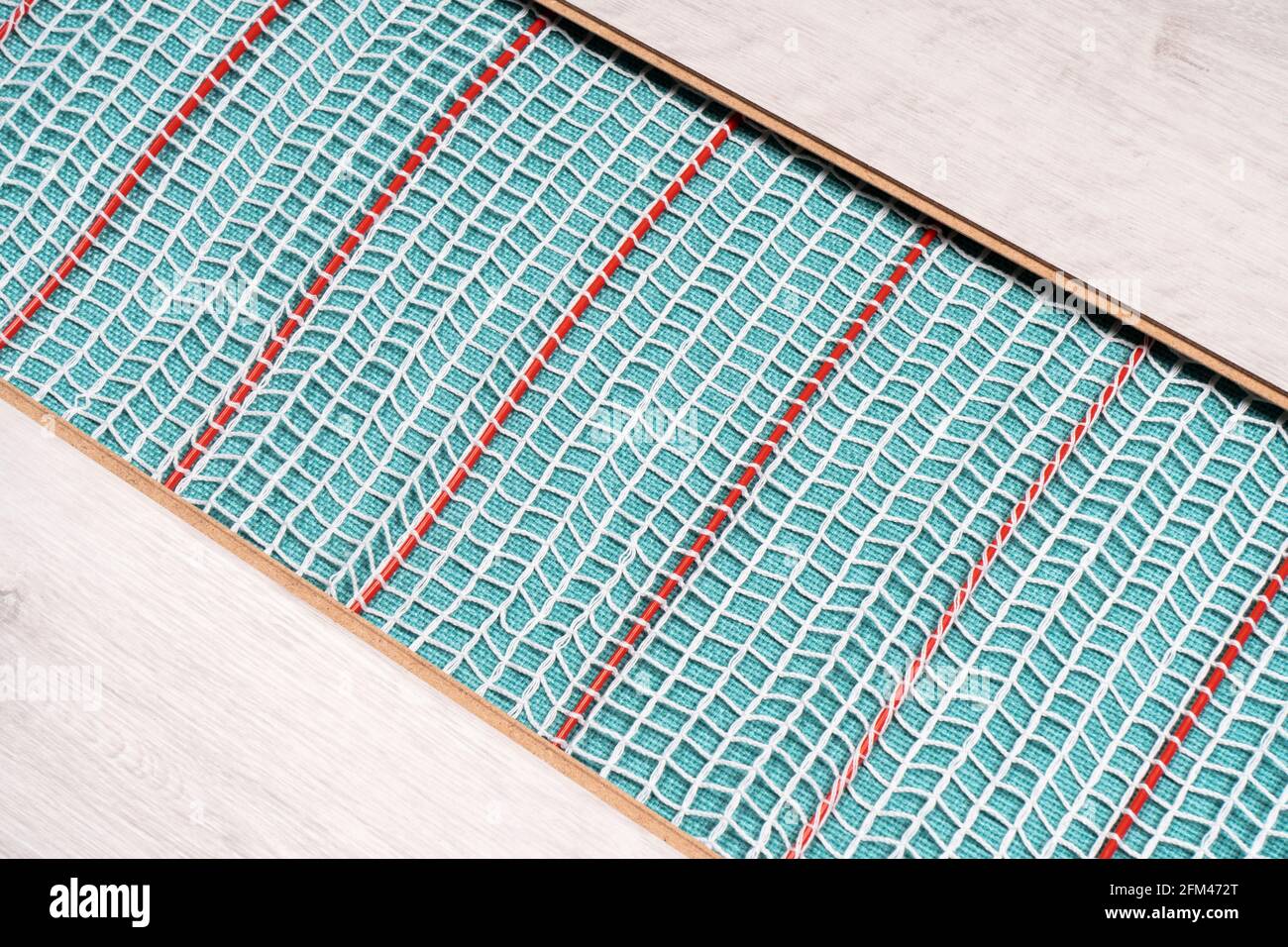 Heated floor under laminate background. Underfloor electric heating. Warm floor system texture
