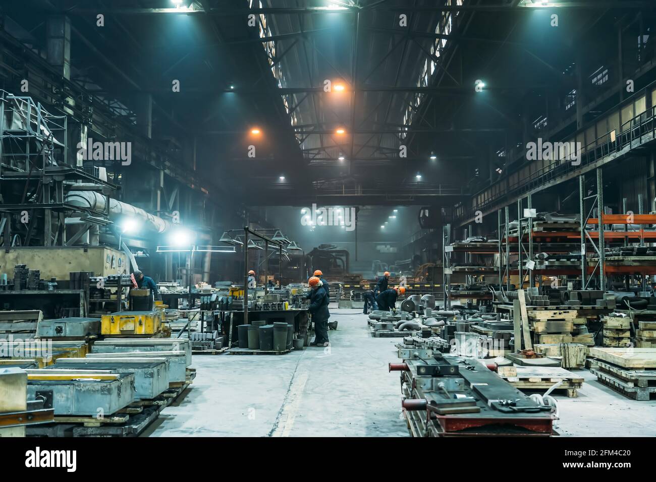 Steel Factory with workers in process of work, industrial interior, large hangar with iron production. Stock Photo