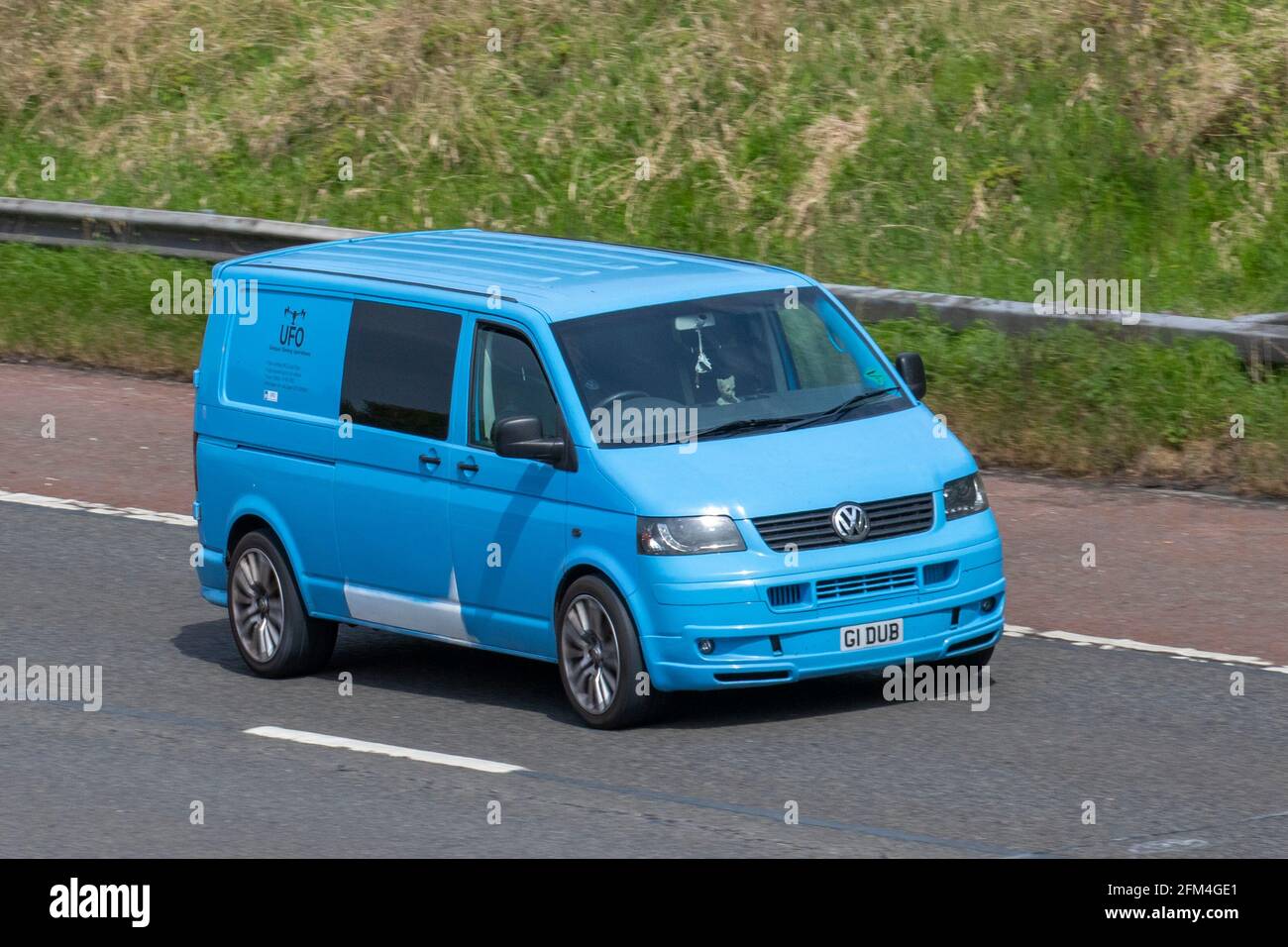 2004 blue Vw Volkswagen T-Sporter T30 174 Tdi Lwb window van, 2460cc diesel panel van; moving vehicles, cars, vehicle driving,  roads, motors, motoring,  UK road network. Stock Photo