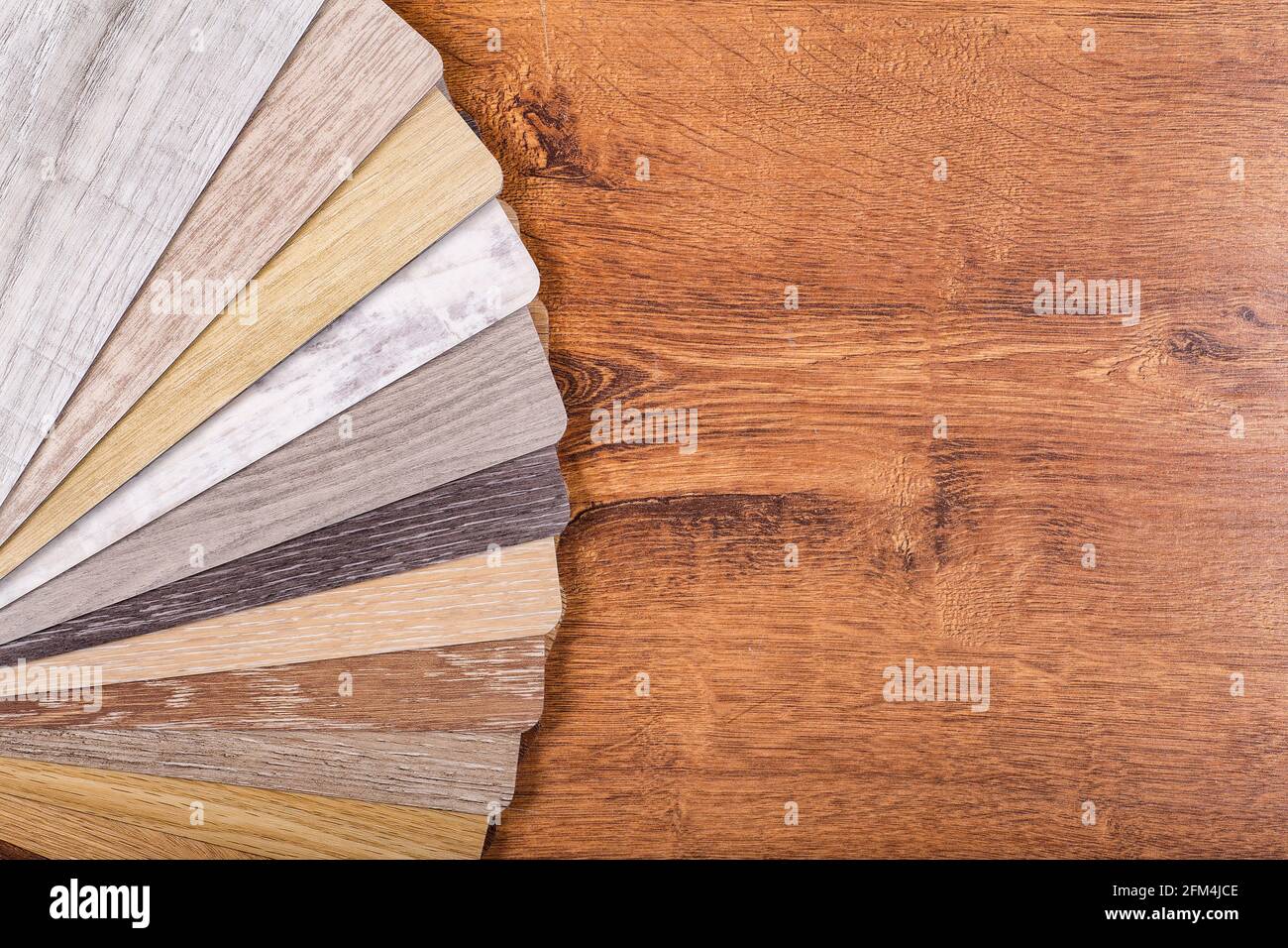 Vinyl and linoleum samples on a white isolated background. Vinyl for flooring with wood grain texture and pattern. High quality photo Stock Photo