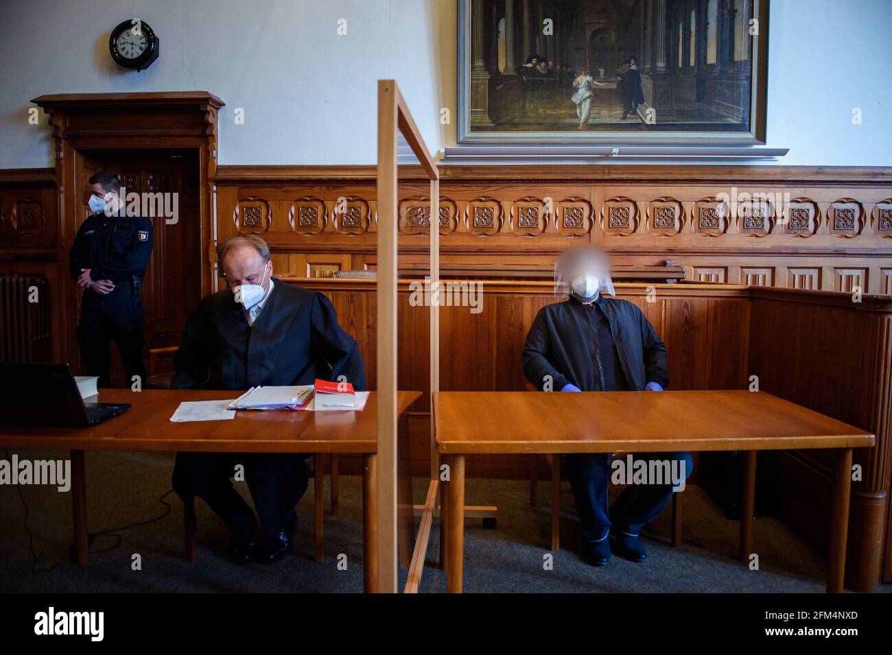 Flensburg, Germany. 06th May, 2021. The defendant (r) sits next to his