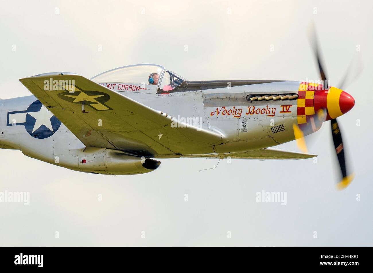 North American P-51 Mustang fighter plane named Nooky Booky IV flying a display at an airshow. Second World War airplane Stock Photo