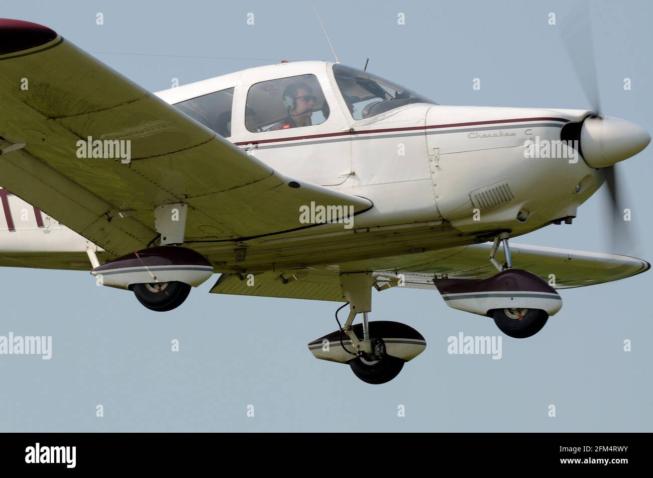 Piper PA28 Cherokee light plane on approach to land at Earls Colne airfield. Pilot and copilot