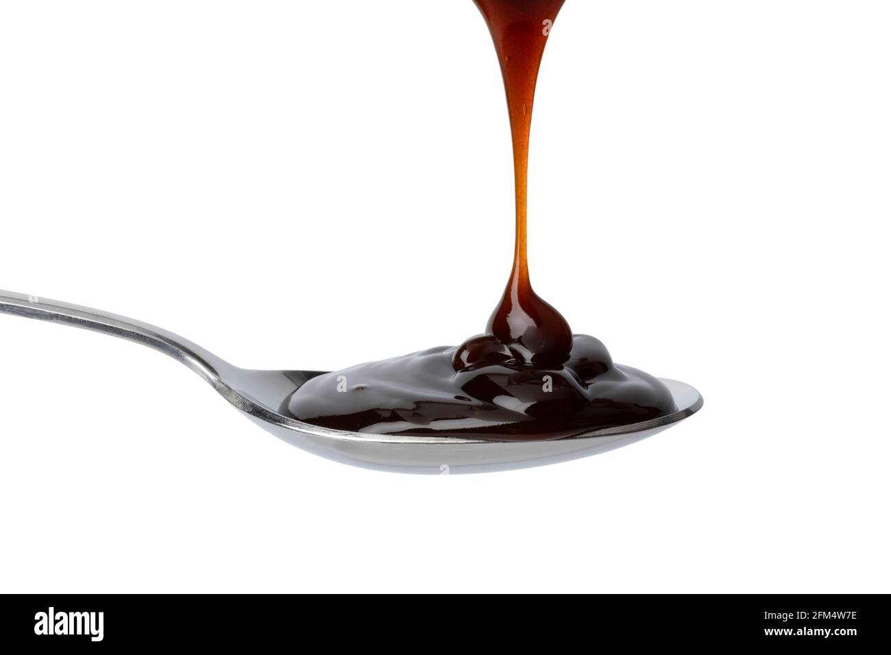 Spoon with thick brown oyster sauce close up  isolated on white background Stock Photo