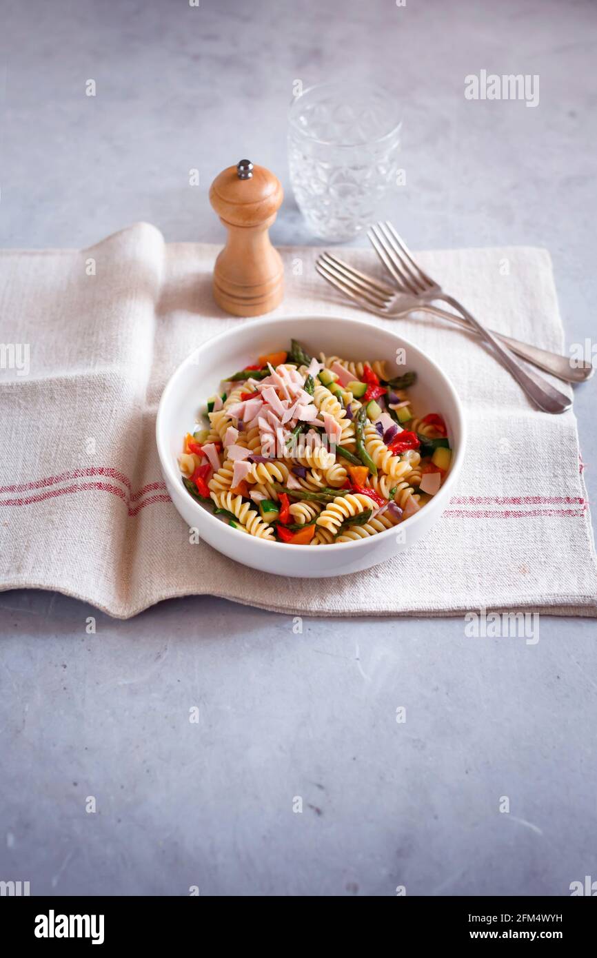 Pasta salad with baked ham and vegetables Stock Photo - Alamy