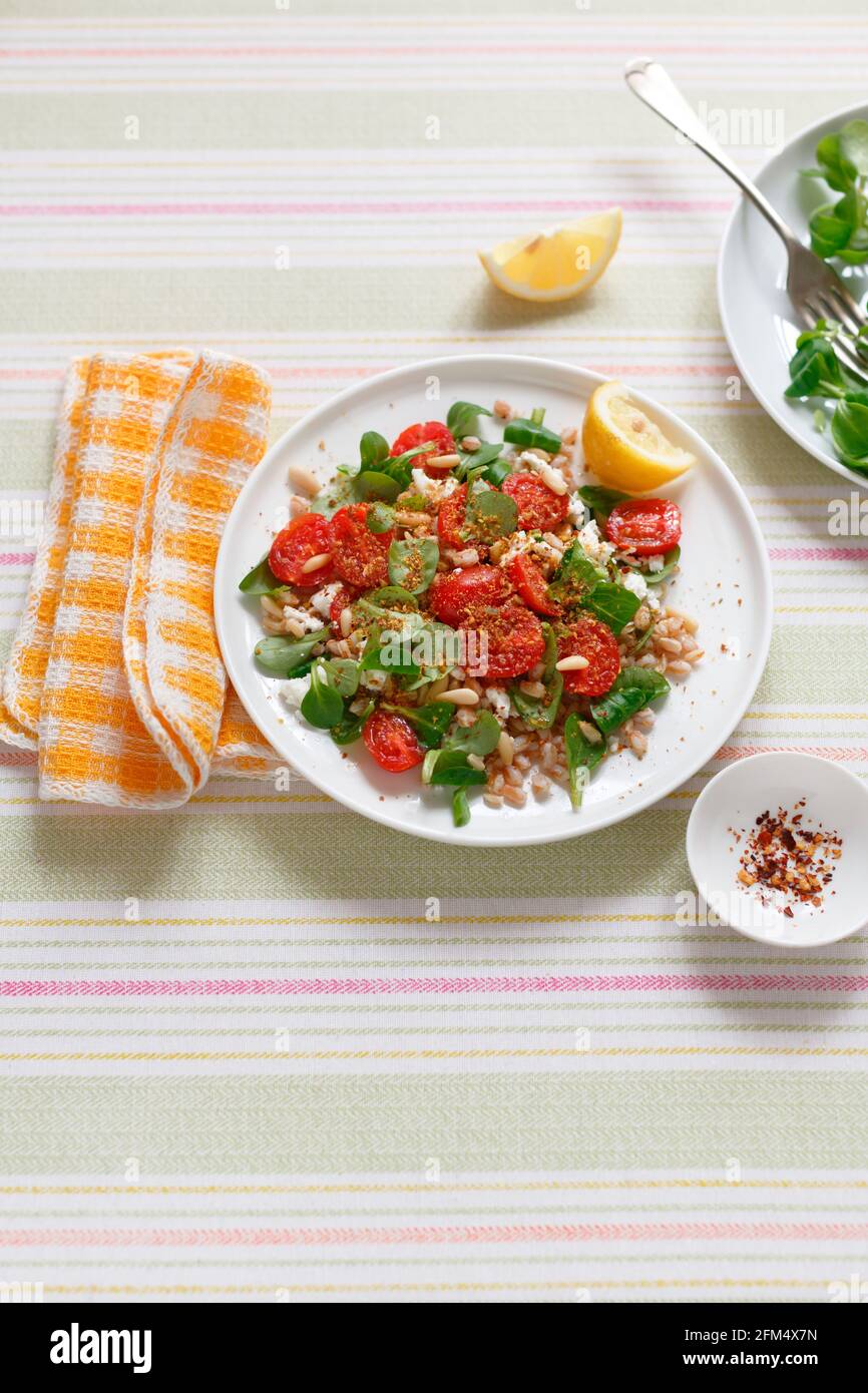 Cereal salad with marinated dates almond feta and pine nuts Stock Photo