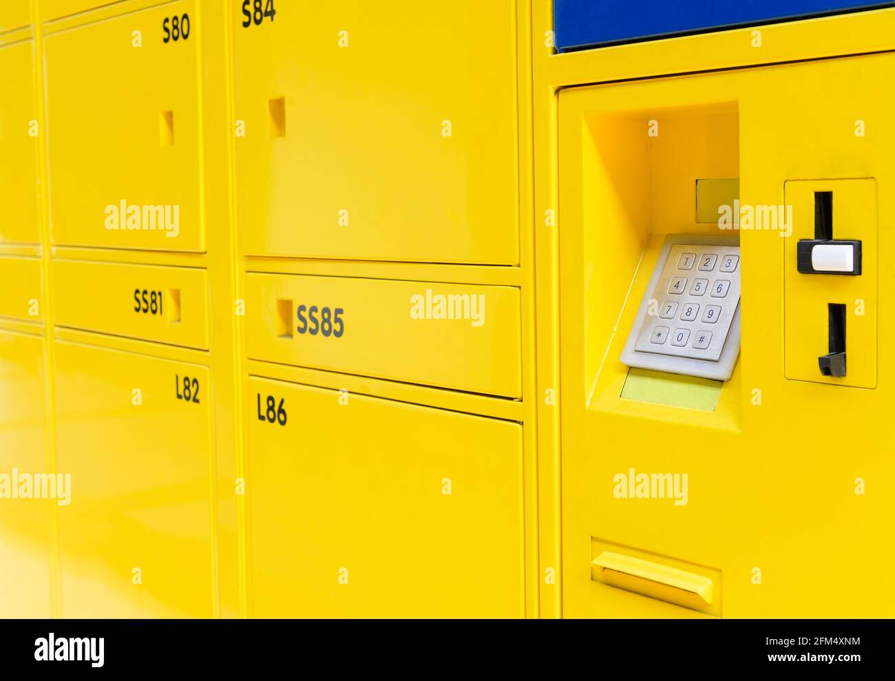 Yellow lockers doors with electric code locks Stock Photo