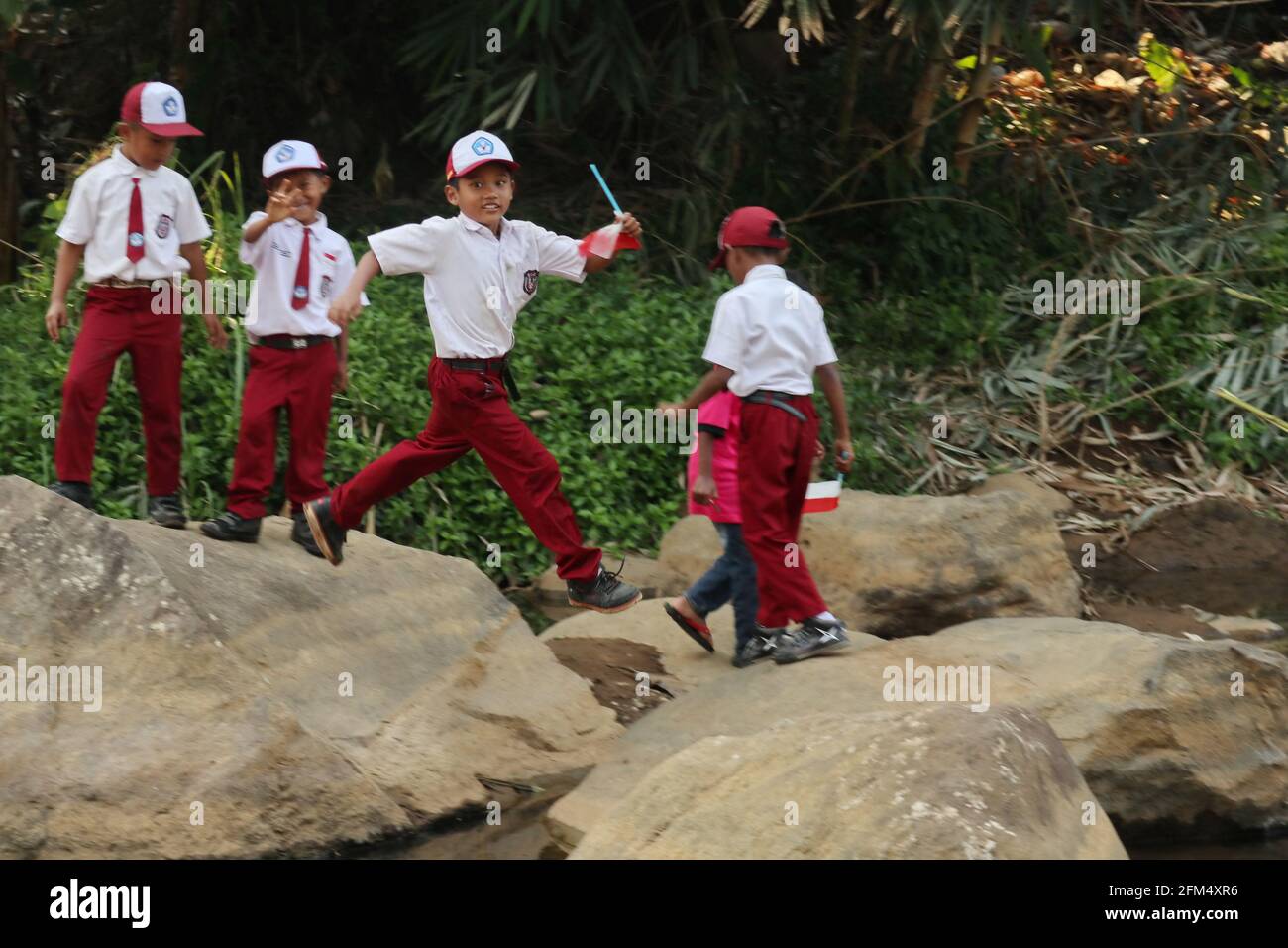 Group of elementary school students playing by the river Stock Photo