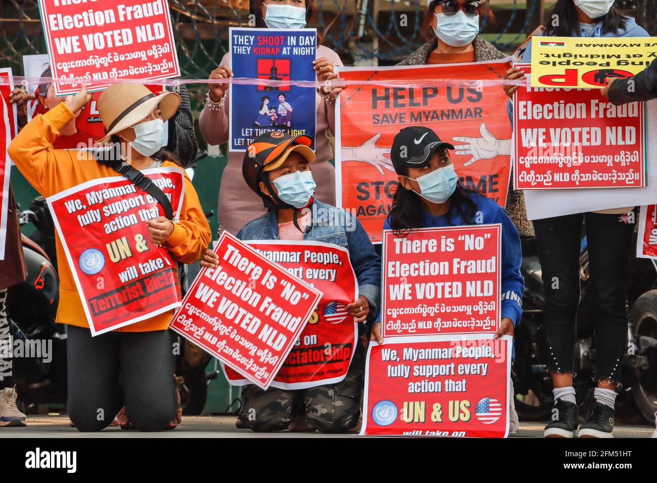 February 17, 2021, Lashio, North Shan State, Myanmar: Anti-military coup protesters hold placards reading ''We voted NLD, We need the help of UN & US'' during a peaceful demonstration against the military coup..A massive crowd took to the streets of Lashio to protest against the military coup and demanded the release of Aung San Suu Kyi. Myanmar's military detained State Counsellor of Myanmar Aung San Suu Kyi on February 01, 2021 and declared a state of emergency while seizing the power in the country for a year after losing the election against the National League for Democracy (Credit Imag Stock Photo