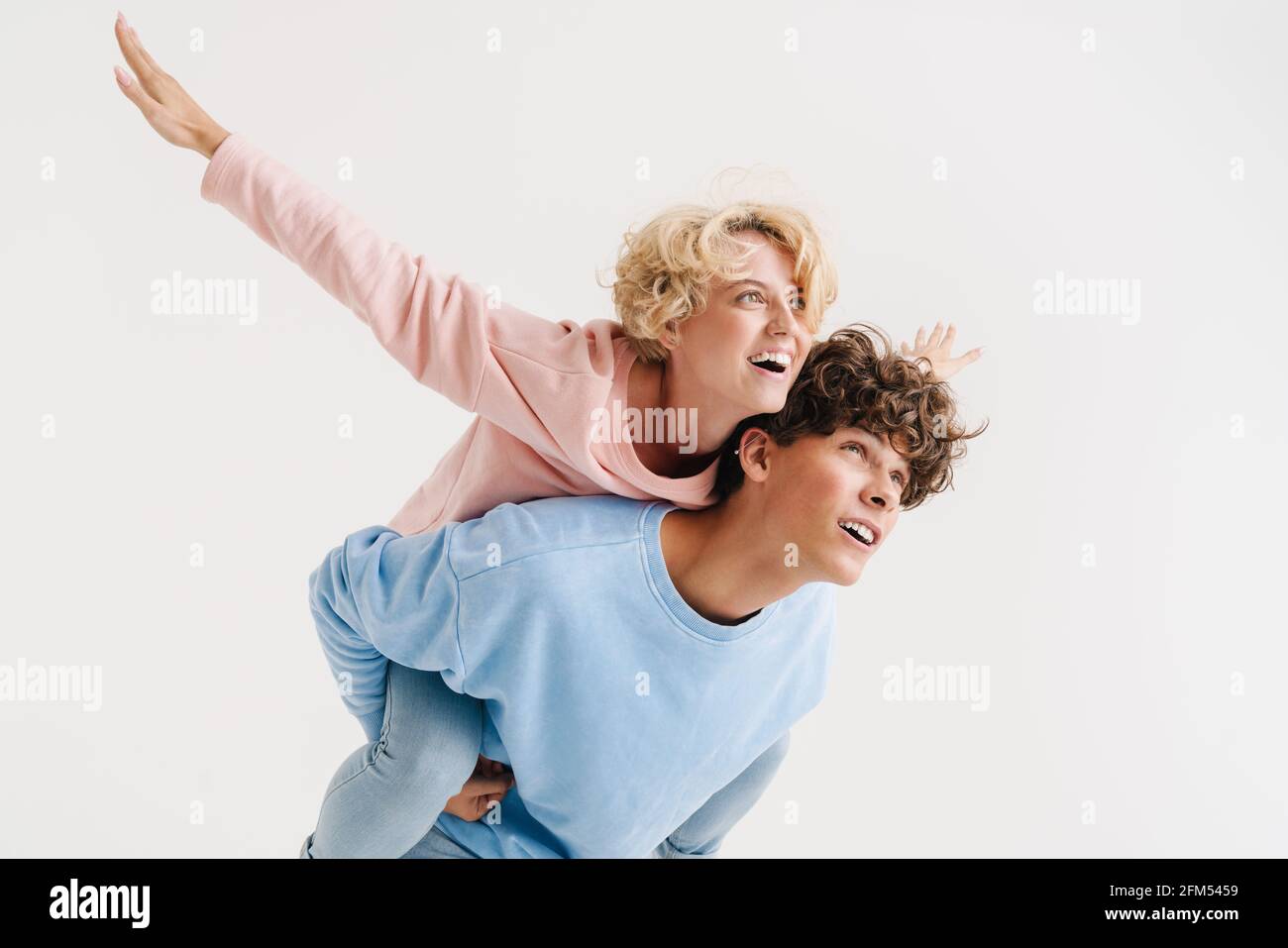 Image of young happy loving couple having fun isolated over white ...
