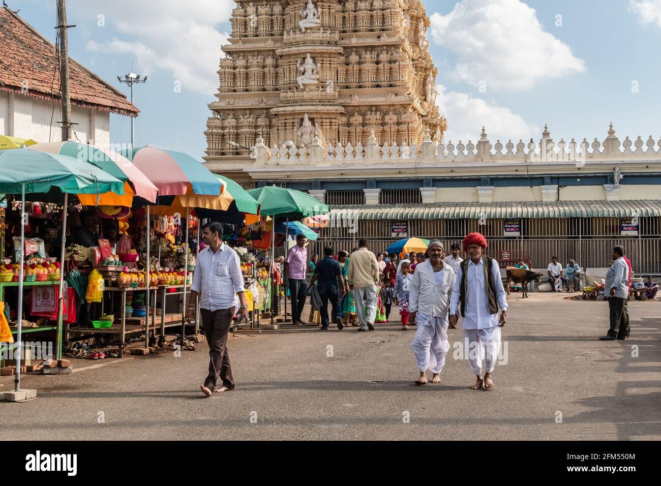 Mysuru, Karnataka, India - January 2019: People walking on a busy street leading to the ancient Hindu temple of Chamundeshwari at the Chamunda Hills n Stock Photo