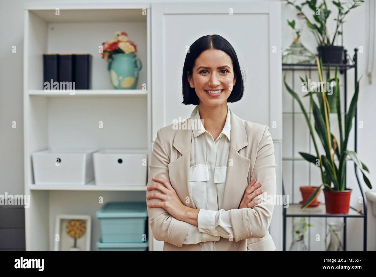 portrait of a beautiful young woman in a white blouse and black suit ...