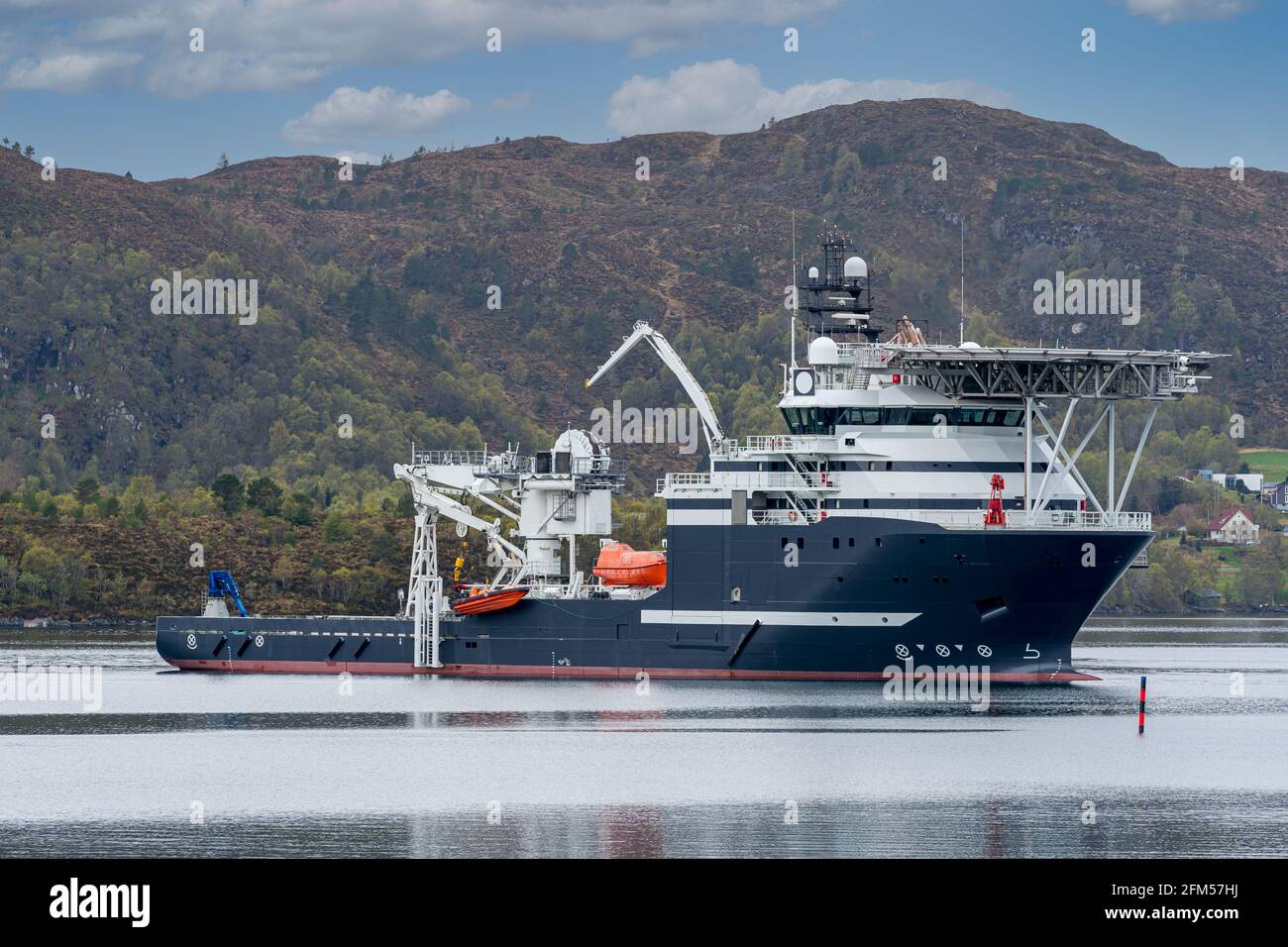 ULSTEINVIK, NORWAY - 2020 MAY 07. Multipurpose Offshore Vessel with big offshore crane inside the Norwegian fjord Stock Photo