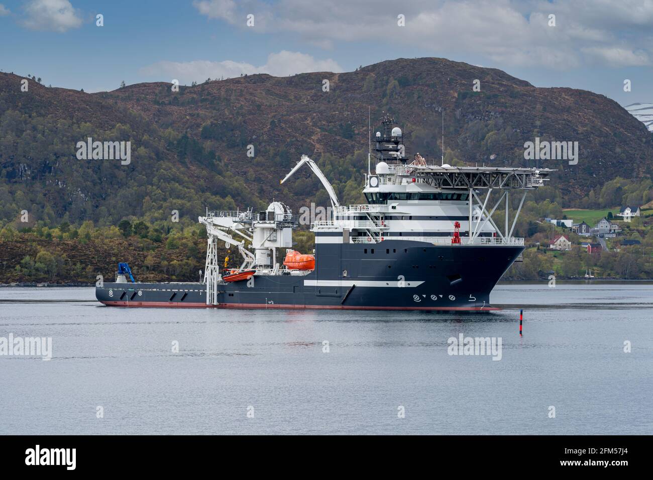 ULSTEINVIK, NORWAY - 2020 MAY 07. Multipurpose Offshore Vessel with big offshore crane inside the Norwegian fjord Stock Photo