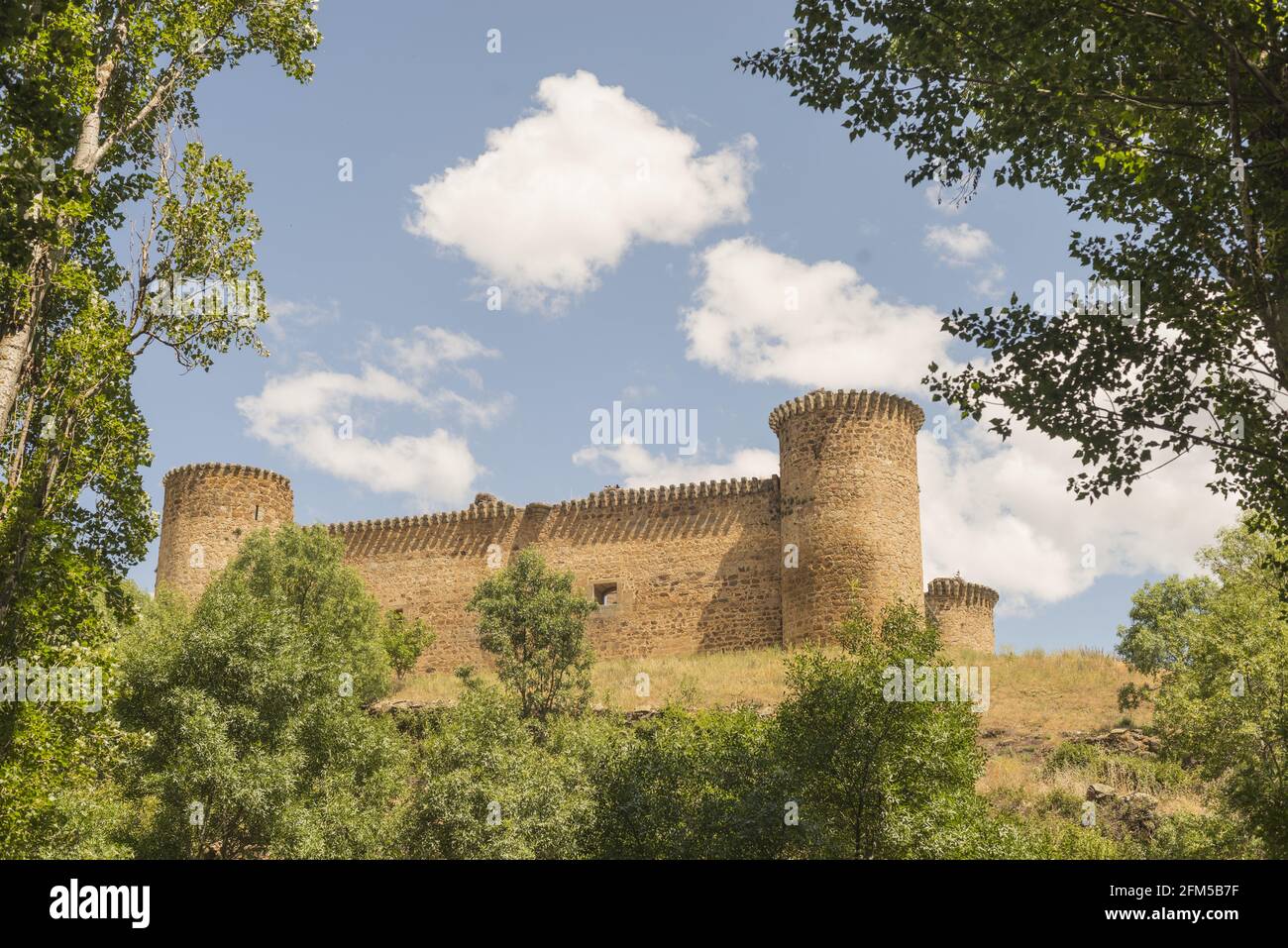 View of the Barco Avila Castilla la Mancha with trees in the foreground under a cloudy sky in Spain Stock Photo