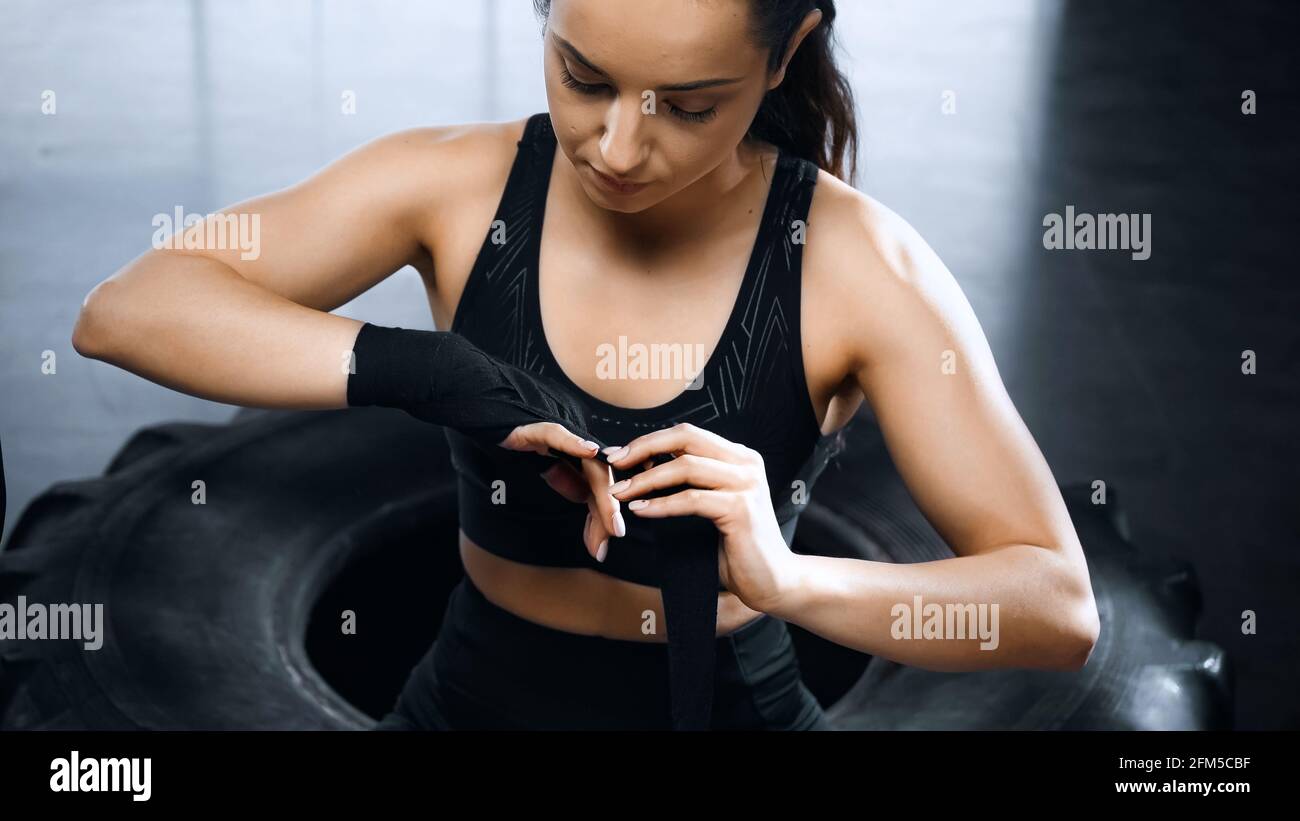 young sportswoman putting on boxing bandages Stock Photo