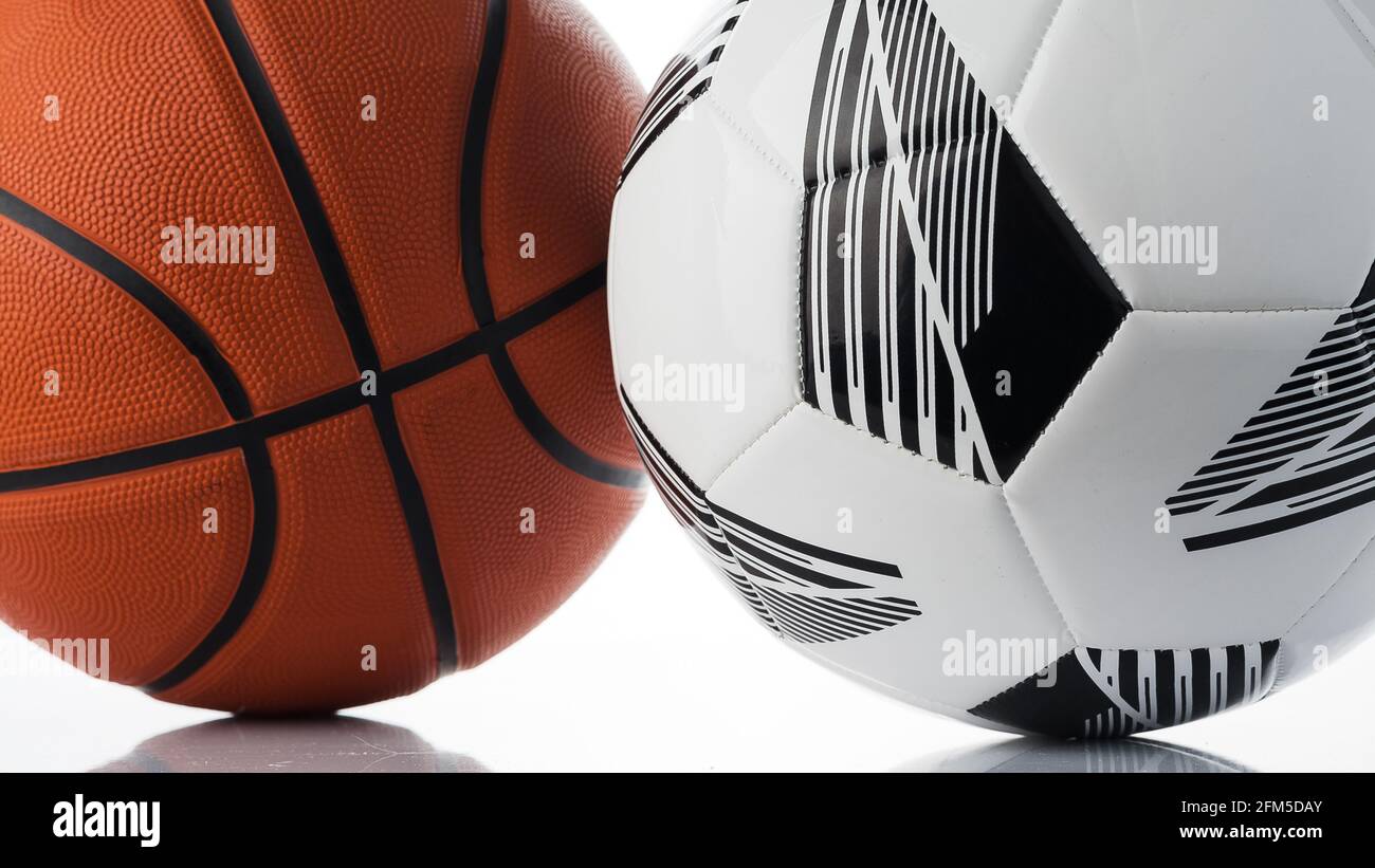 Basketball and soccer ball closeup on a white surface Stock Photo Alamy