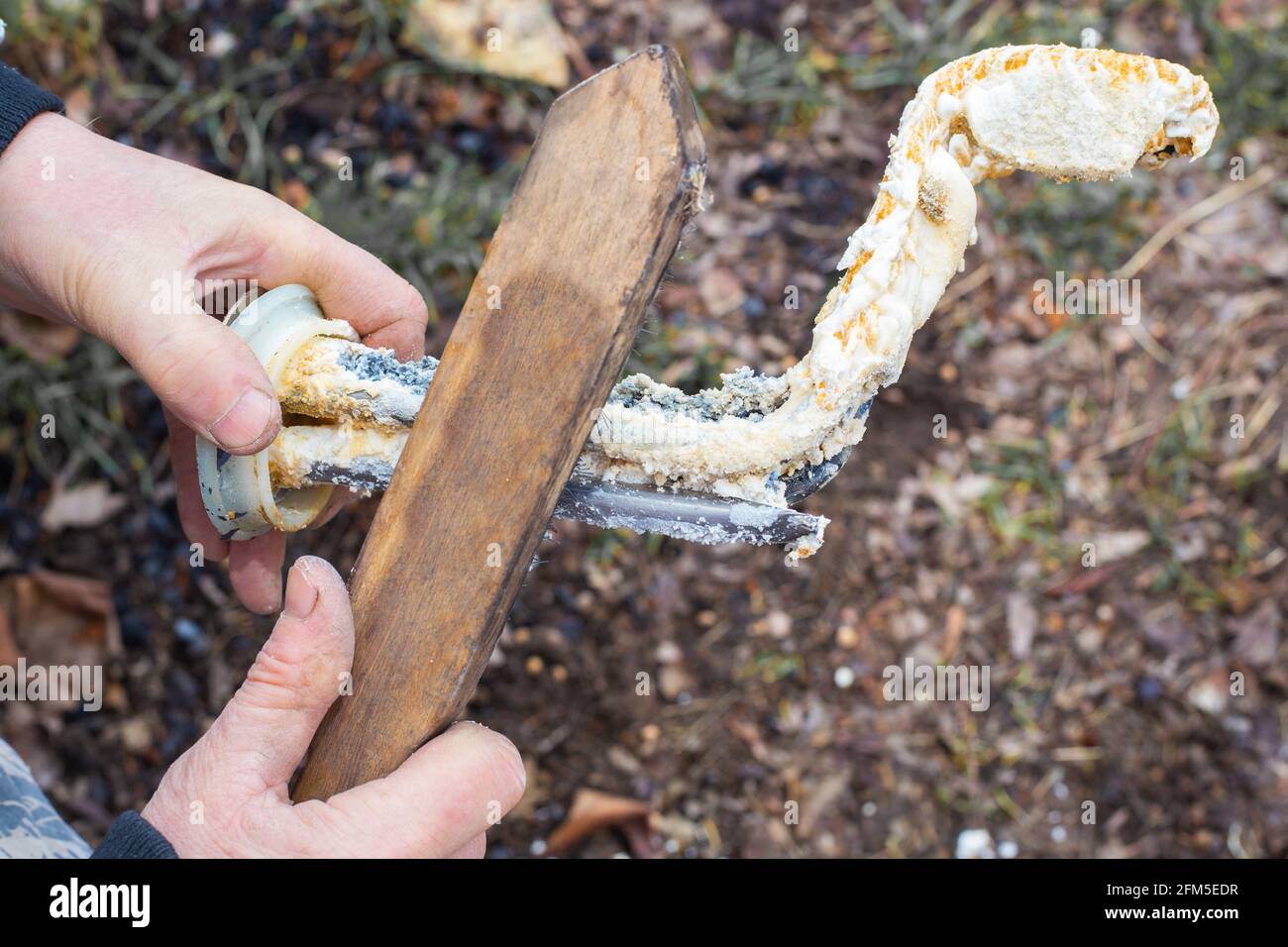 Cleaning the heating element of the boiler. A man cleans scale from TEN