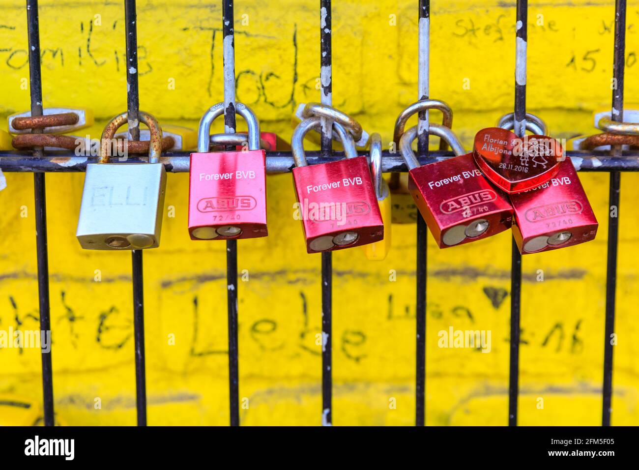 Love locks and fan locks padlocked to a 'Echte Liebe' (true love) fan wall also called 'wall of love' at Signal Iduna Park, Borussia Dortmund BVB 09 Stock Photo