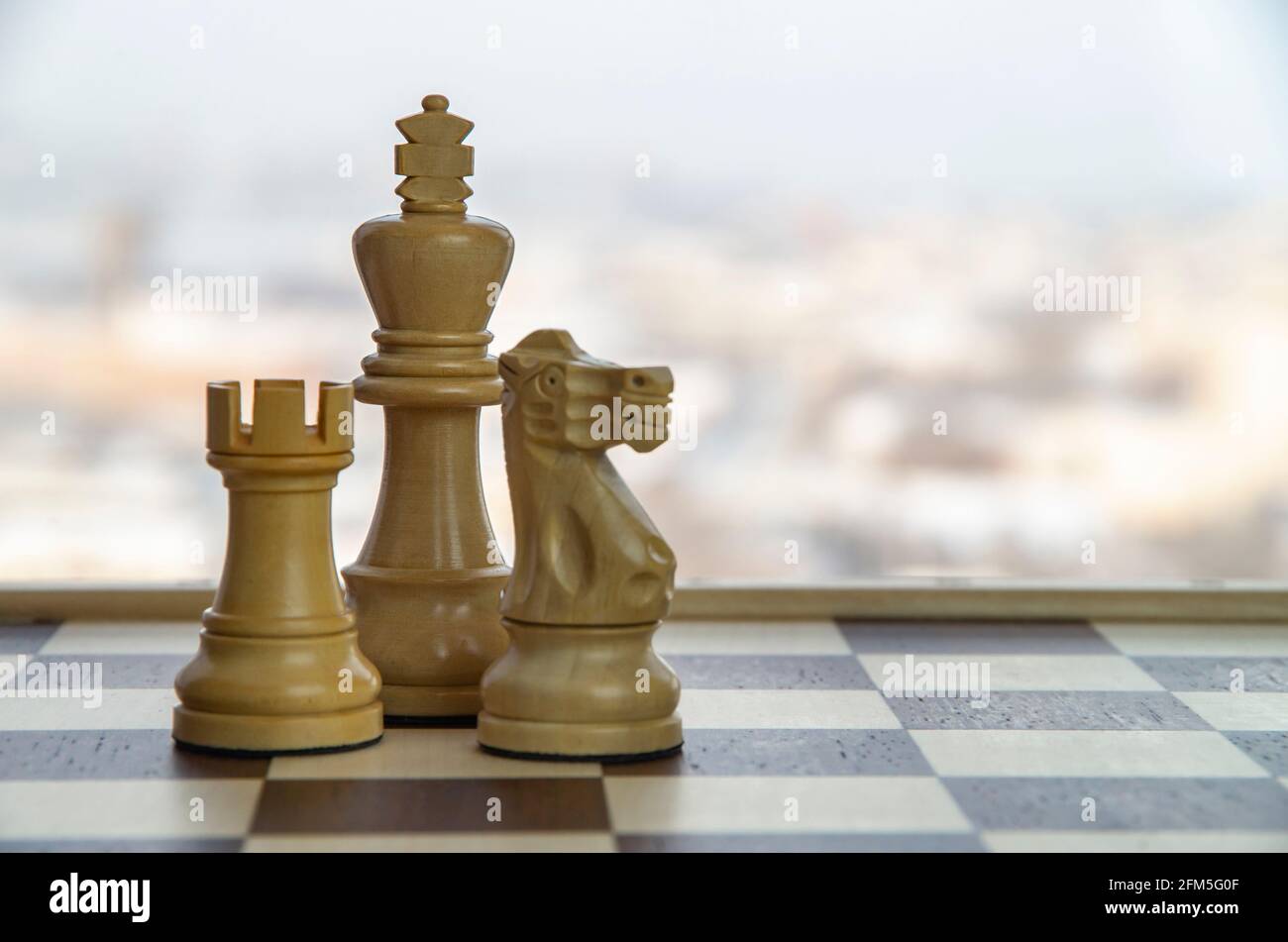 Chess Board with King, Queen and Rook in Checkmate. Stock