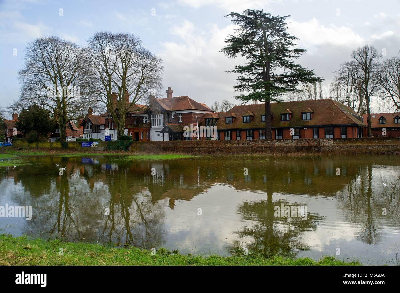 Cookham, Berkshire, UK. 2nd February, 2021. Flooding outside the Chartered Institute of Marketing in Cookham. A Flood Alert is in place in Cookham as the River Thames has burst it's banks. The B4447 road across Cookham Moor has been closed as it is flooded. The Environment Agency were on hand today pumping out drains . Credit: Maureen McLean/Alamy Stock Photo