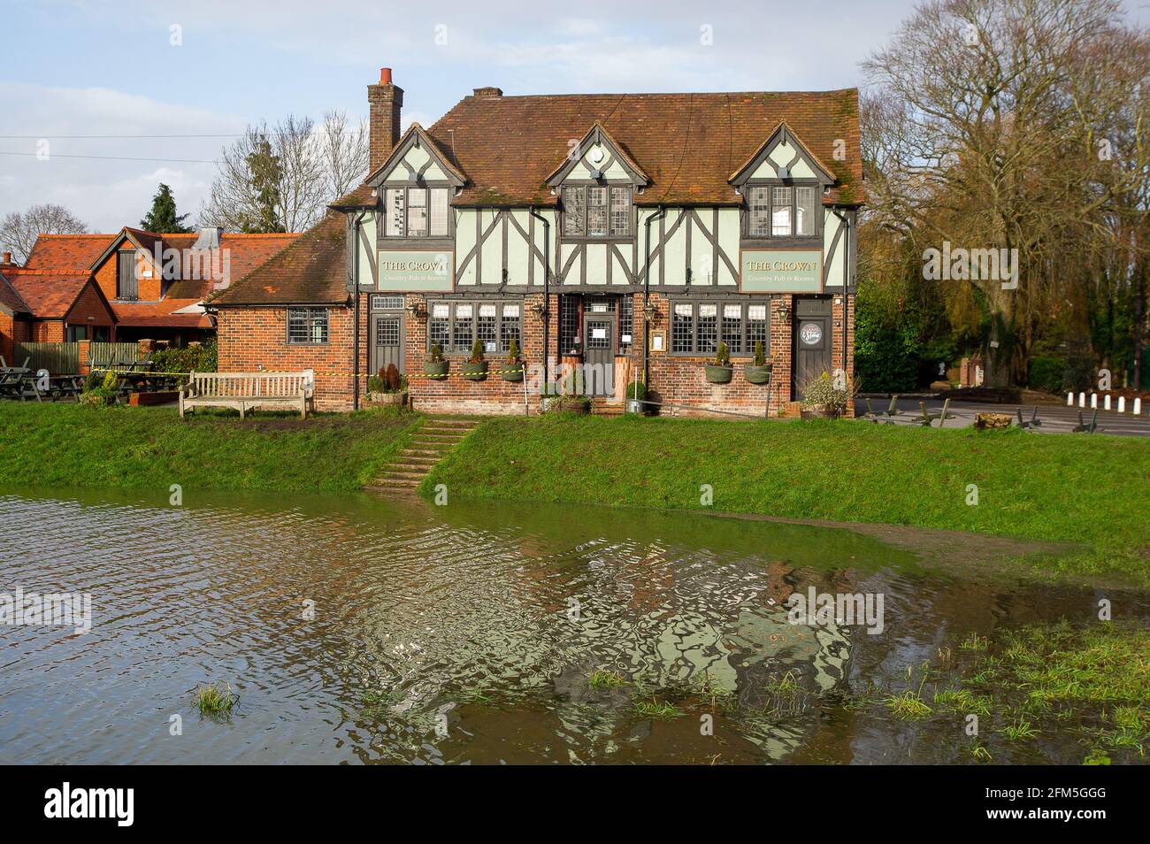 Cookham, Berkshire, UK. 2nd February, 2021. Flooding outside the Crown Pub on Cookham Moor. A Flood Alert is in place in Cookham as the River Thames has burst it's banks. The B4447 road across Cookham Moor has been closed as it is flooded. The Environment Agency were on hand today pumping out drains . Credit: Maureen McLean/Alamy Stock Photo