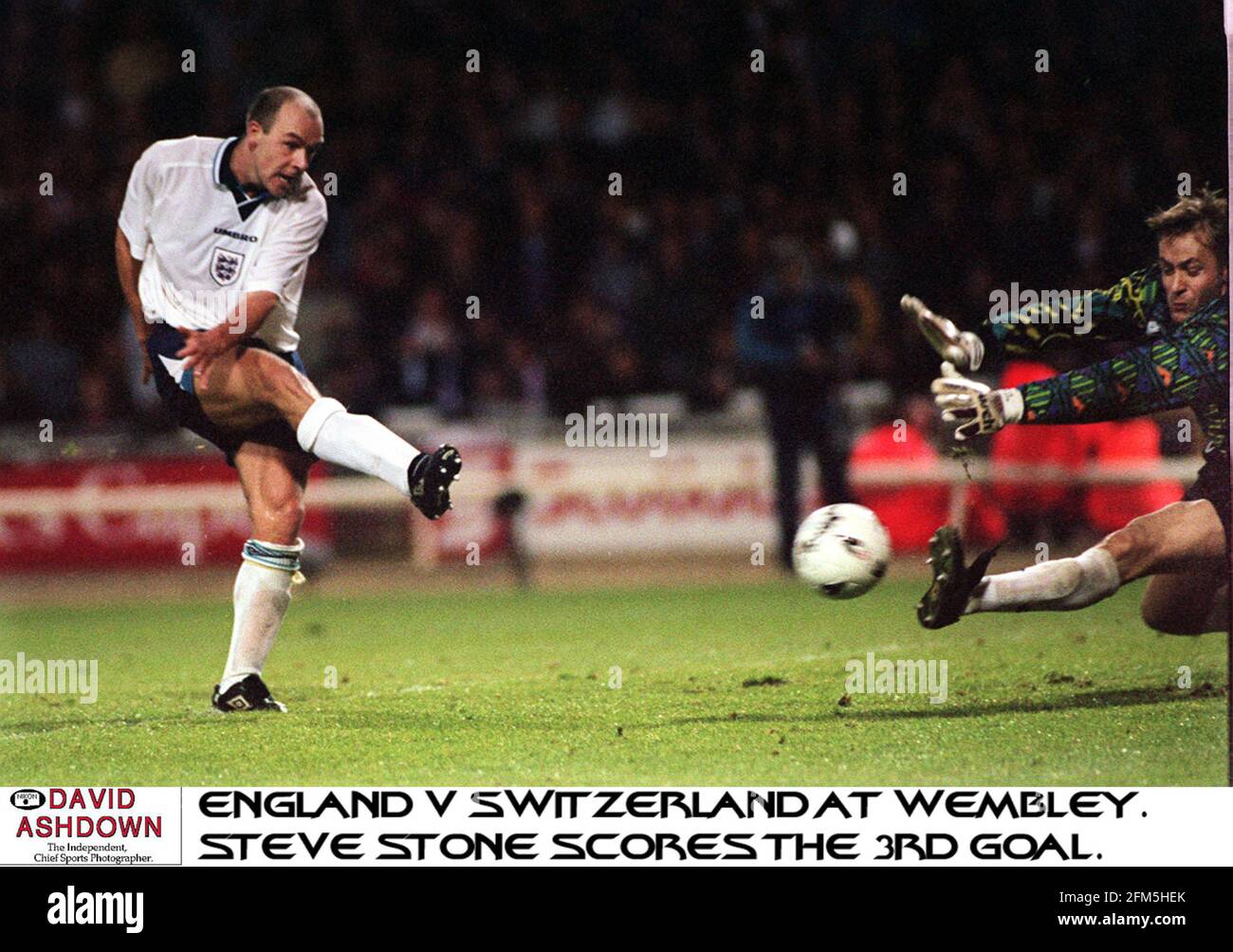 Steve Stone seals an impressive game for his country by scoring his first goal for England  shooting pass the swiss goalkeeper Marco Pascolo Stock Photo